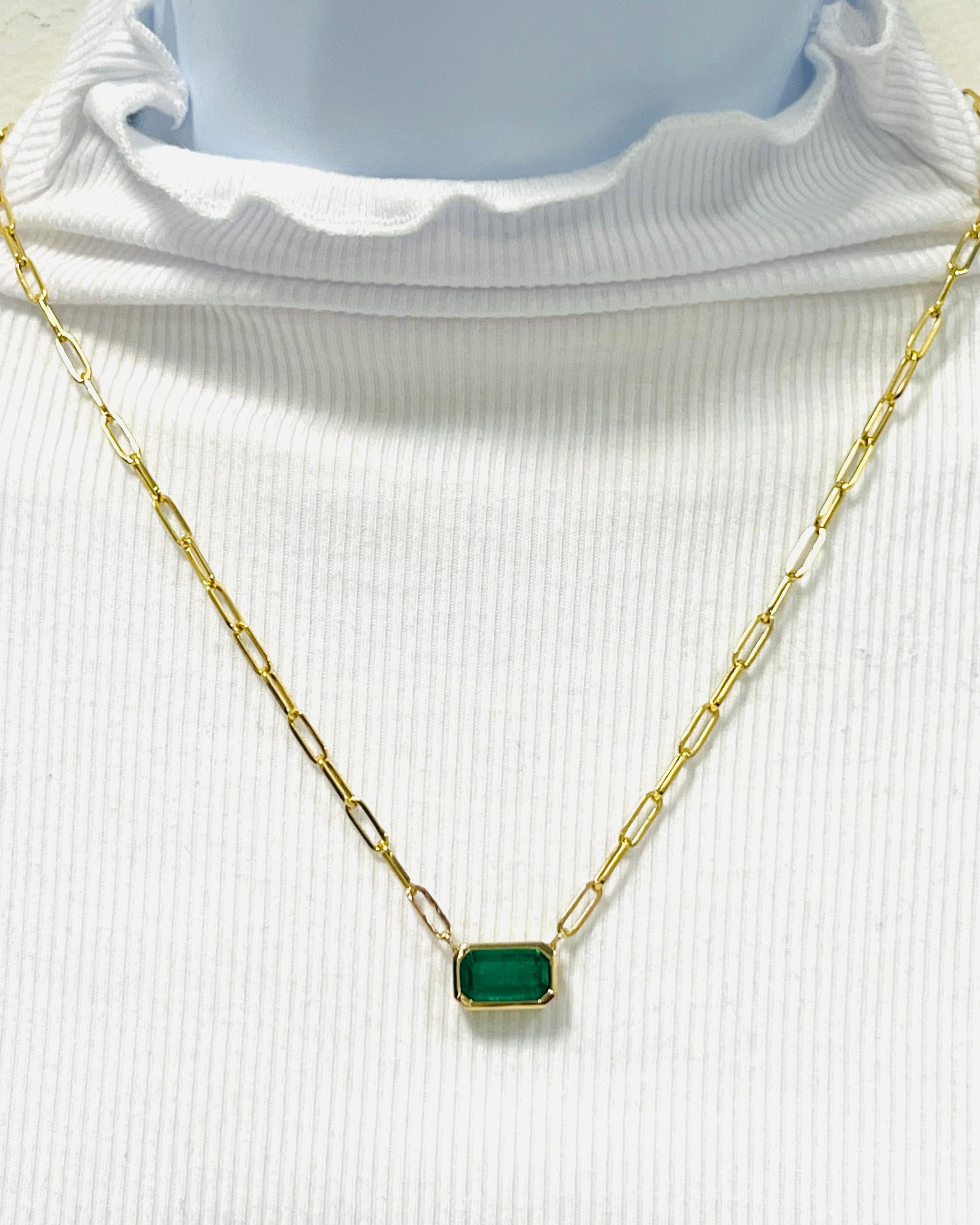 Beautiful 3.74 ct. emerald emerald cut in a handmade 14k yellow gold bezel.  Length is 21