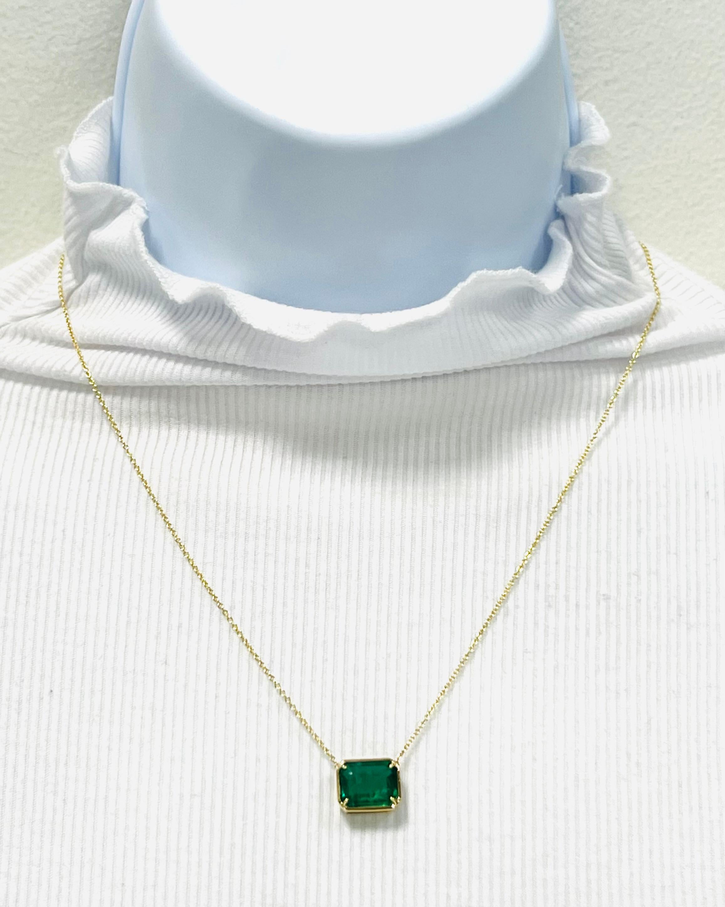 Beautiful 3.31 ct. emerald emerald cut in a 18k yellow gold mounting.  The bezel and prong look is fun and trend forward.  Length is 18