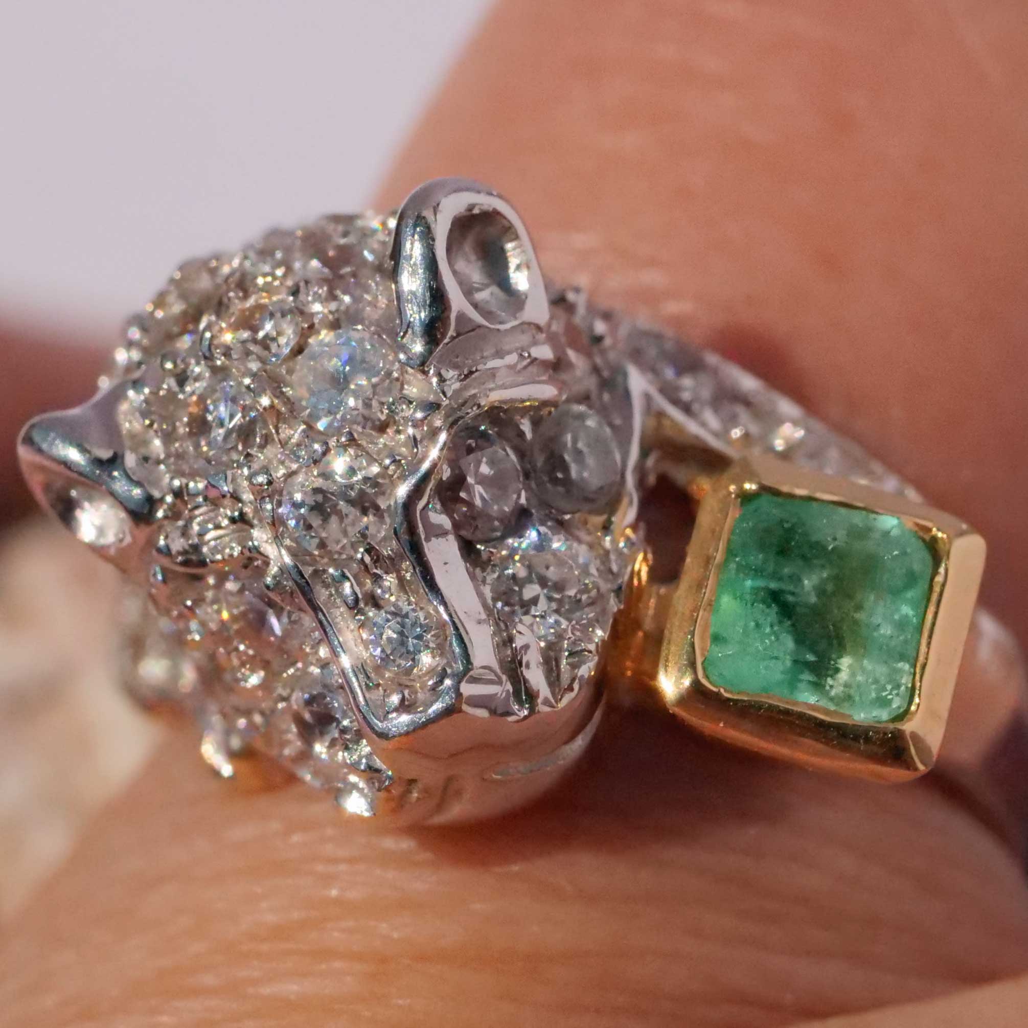 an emerald big cat ring in 750 white gold, partially gold-plated, beautifully designed with lots of zirconia setting for a lot of bling, with carre-shaped emerald in beautiful color quality, approx. 0.25 ct, approx. 21 x 12 x 8.5 mm, approx. weighs