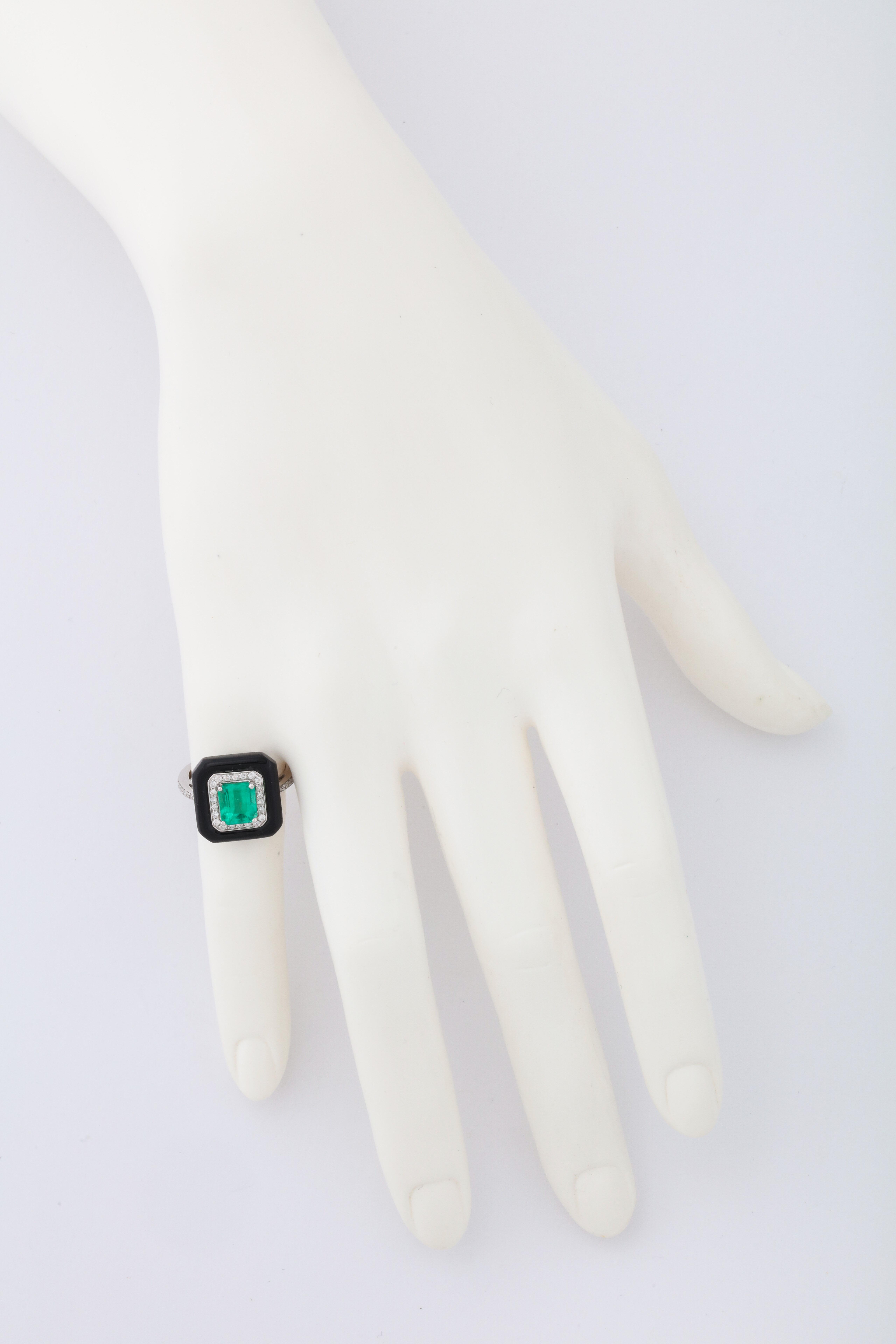 18kt white gold, custom cut black agate, emerald (app. 1.50cts) and diamond ring.  The contrasting colors in this ring take their inspiration from the Art Deco period, while the bright green emerald catches the eye.  Easy to wear and unique in it's
