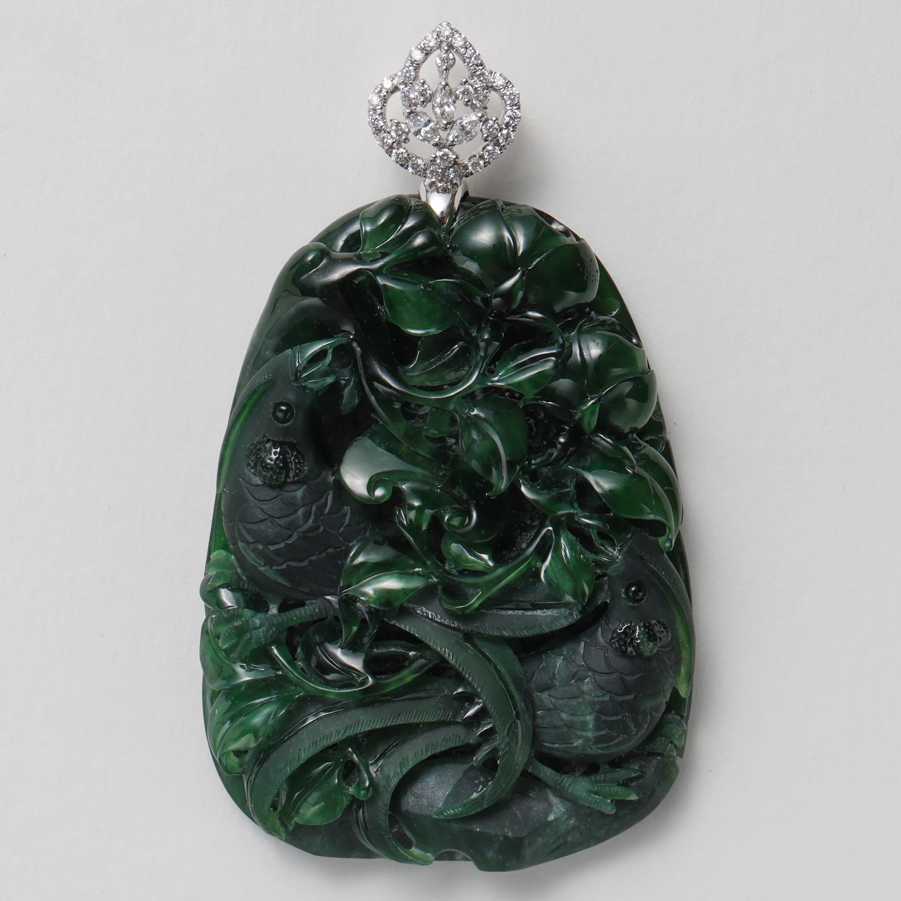 This incredible, substantial, masterfully carved natural and untreated omphacite jade (fei cui) jade pendant features three-dimensionally carved birds nestled among highly detailed wide blades of grass, while coyly discrete ruyi (mushroom) are