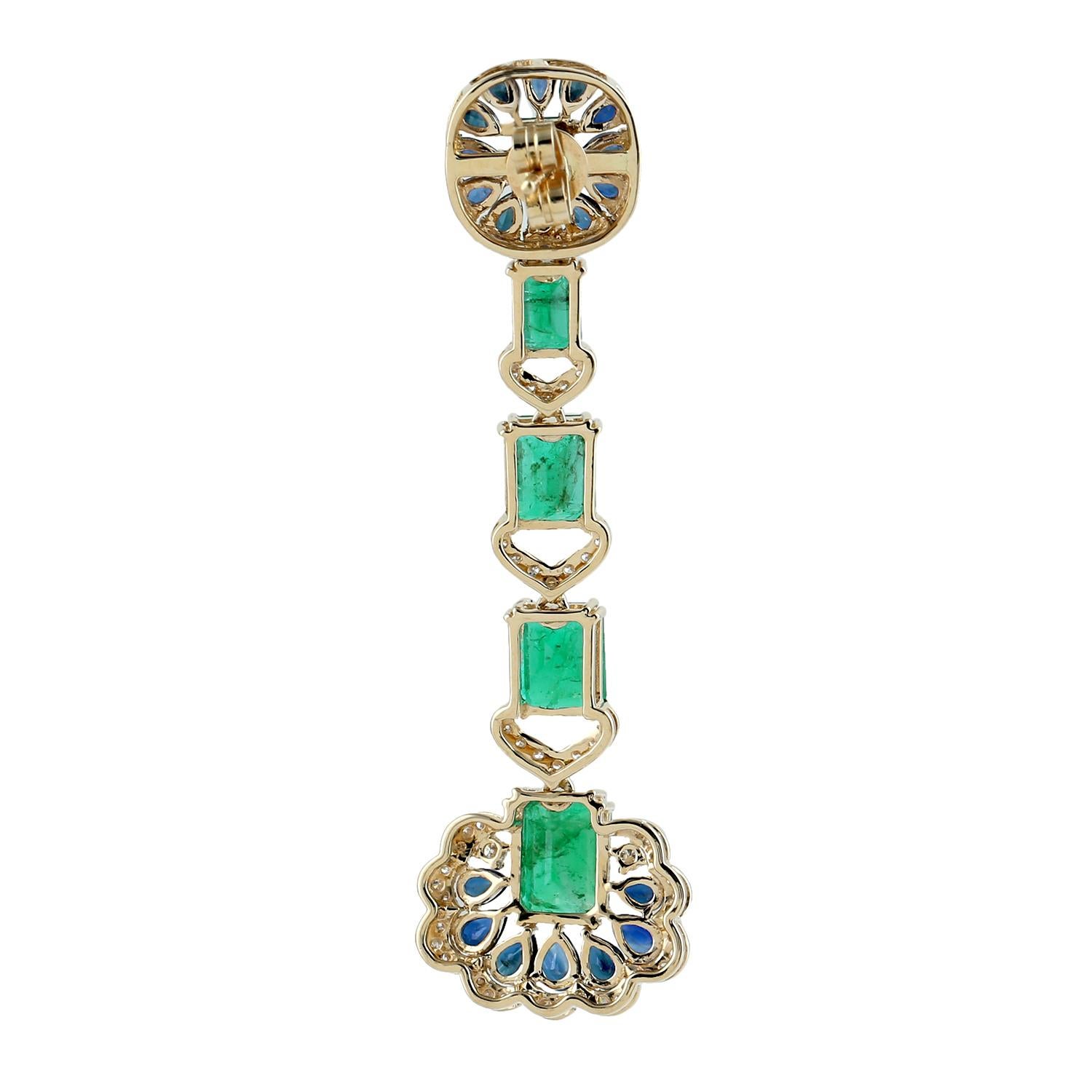 Designer Antique looking Emerald, Blue Sapphire and Diamond earring set in 18K Gold is a pretty fashionable earring.

18K Gold: 15.07gms
Diamond: 1.1cts
Emerald: 11.05cts
Blue Sapphire: 6.15cts