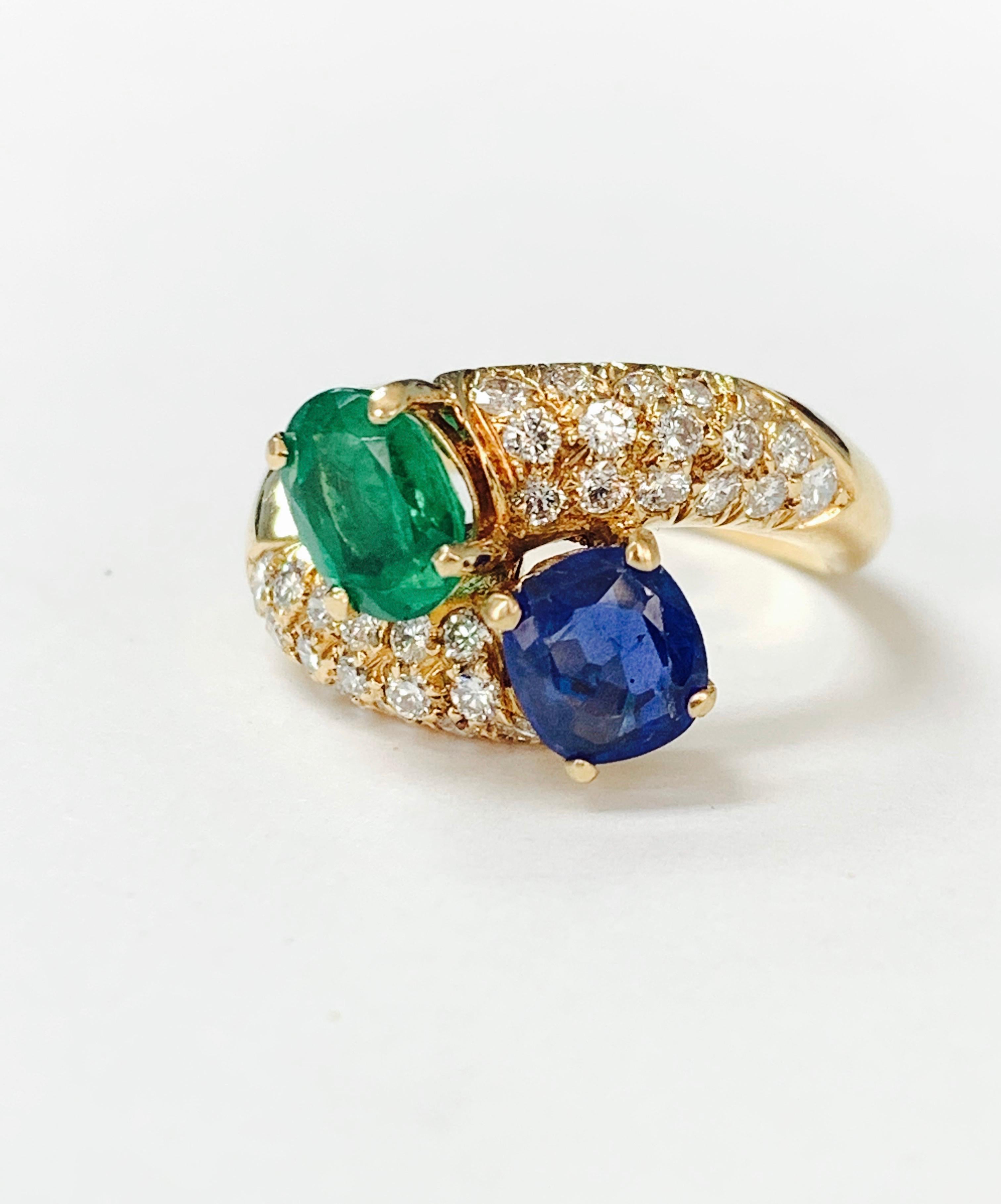 Emerald, blue sapphire and diamond twin ring beautifully handcrafted in 18k yellow gold. 
The details are as follows : 
Emerald weight : 1.25 carat 
Blue sapphire weight : 1.15 carat 
Diamond weight : 0.75 carat 
Metal : 18k Yellow gold 
Ring size :