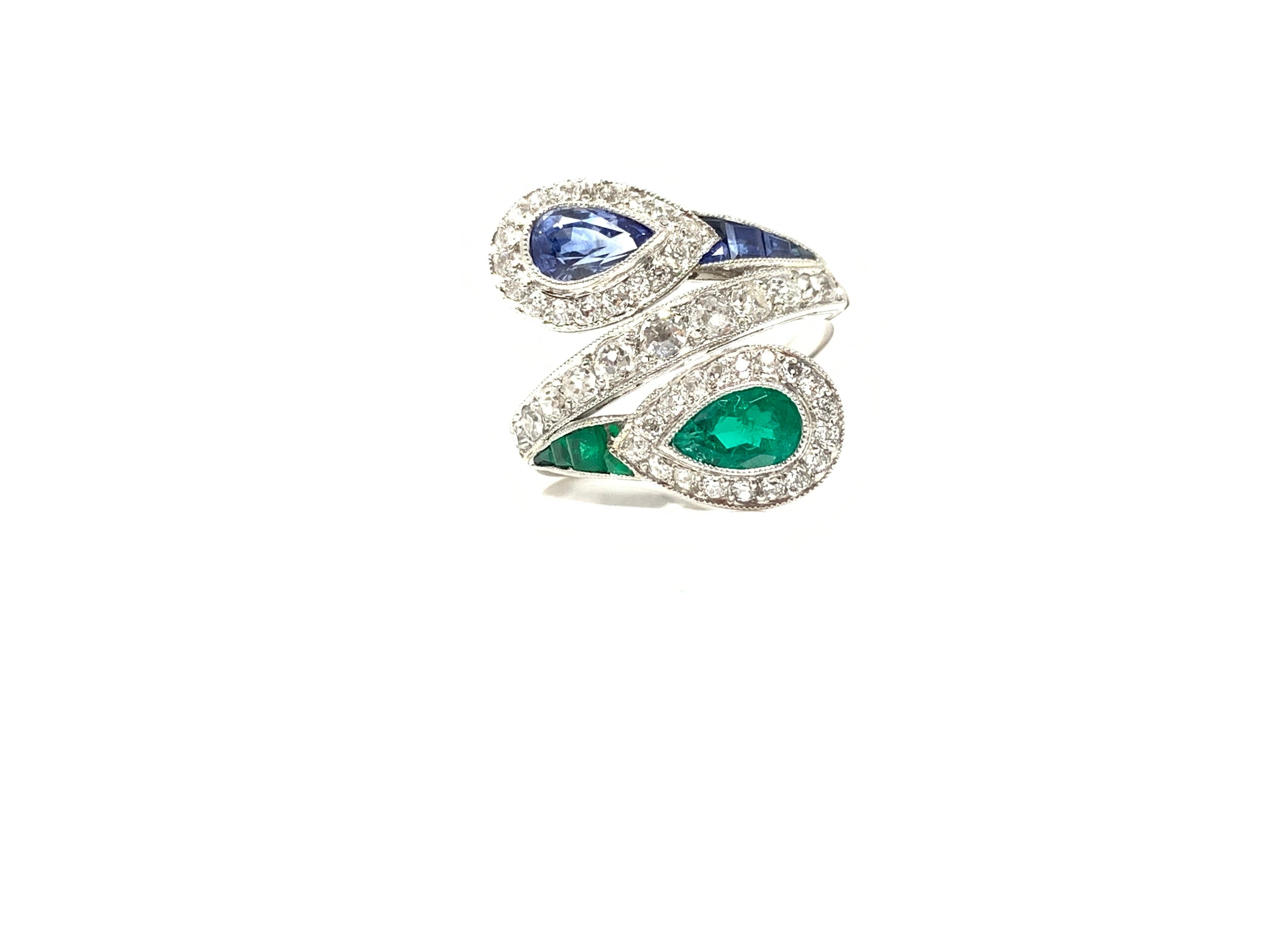 This unique one of a kind twin ring is handmade in platinum. This beautiful ring is sure to get everybody's glance. It features : 
white round brilliant diamond: 1.25 carat ( GH color and VS clarity ) 
Blue Sapphire: 0.75 carat 
Emerald: 0.75 carat