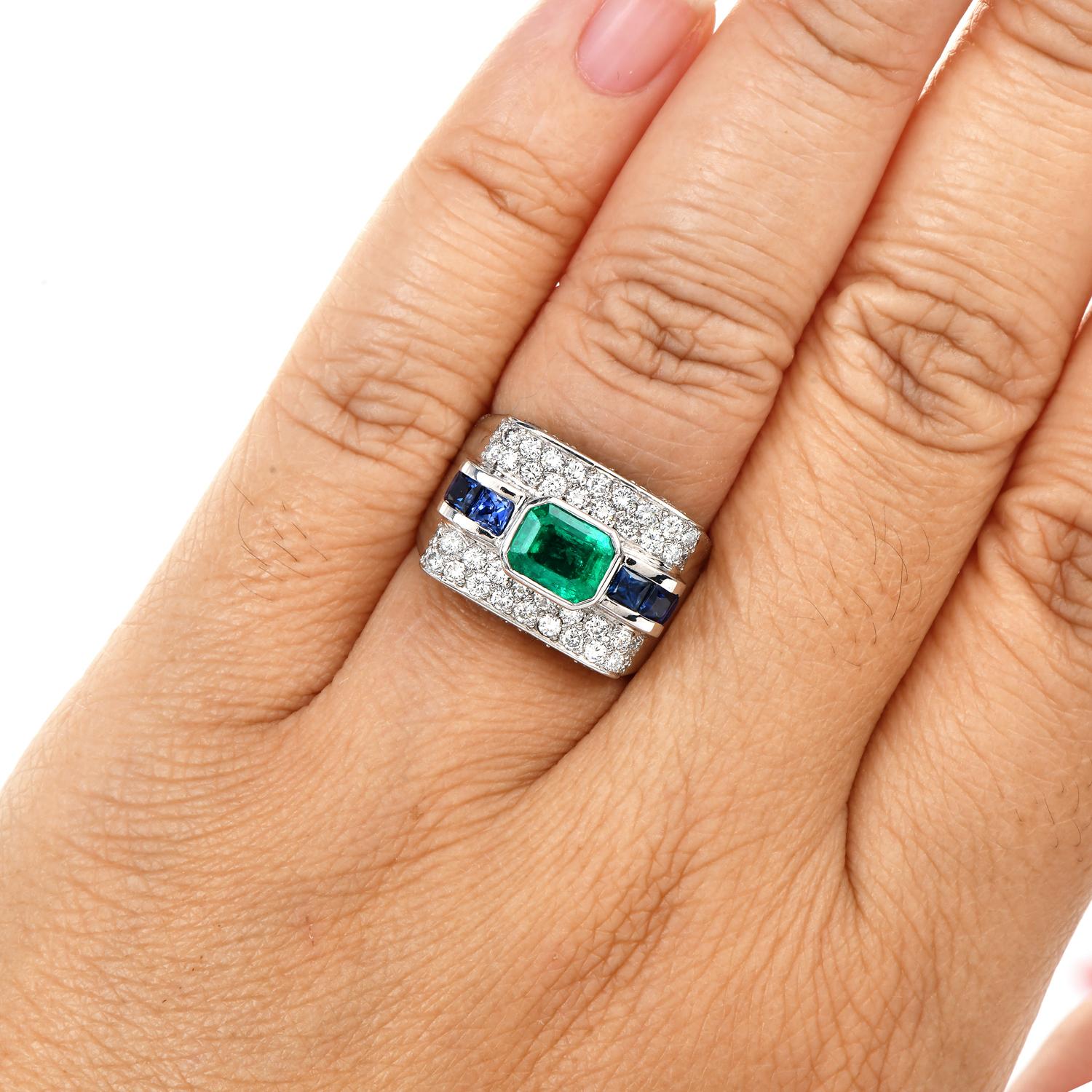 This exquisite  rectangular-shaped cocktail ring with a pave set design ring

Is crafted in solid 18k white gold.

The center exposes one exquisite Green Emerald, Emerald Cut, Bezel Set, weighing approx: 1.01 carats.

sided by (6) Blue Sapphire