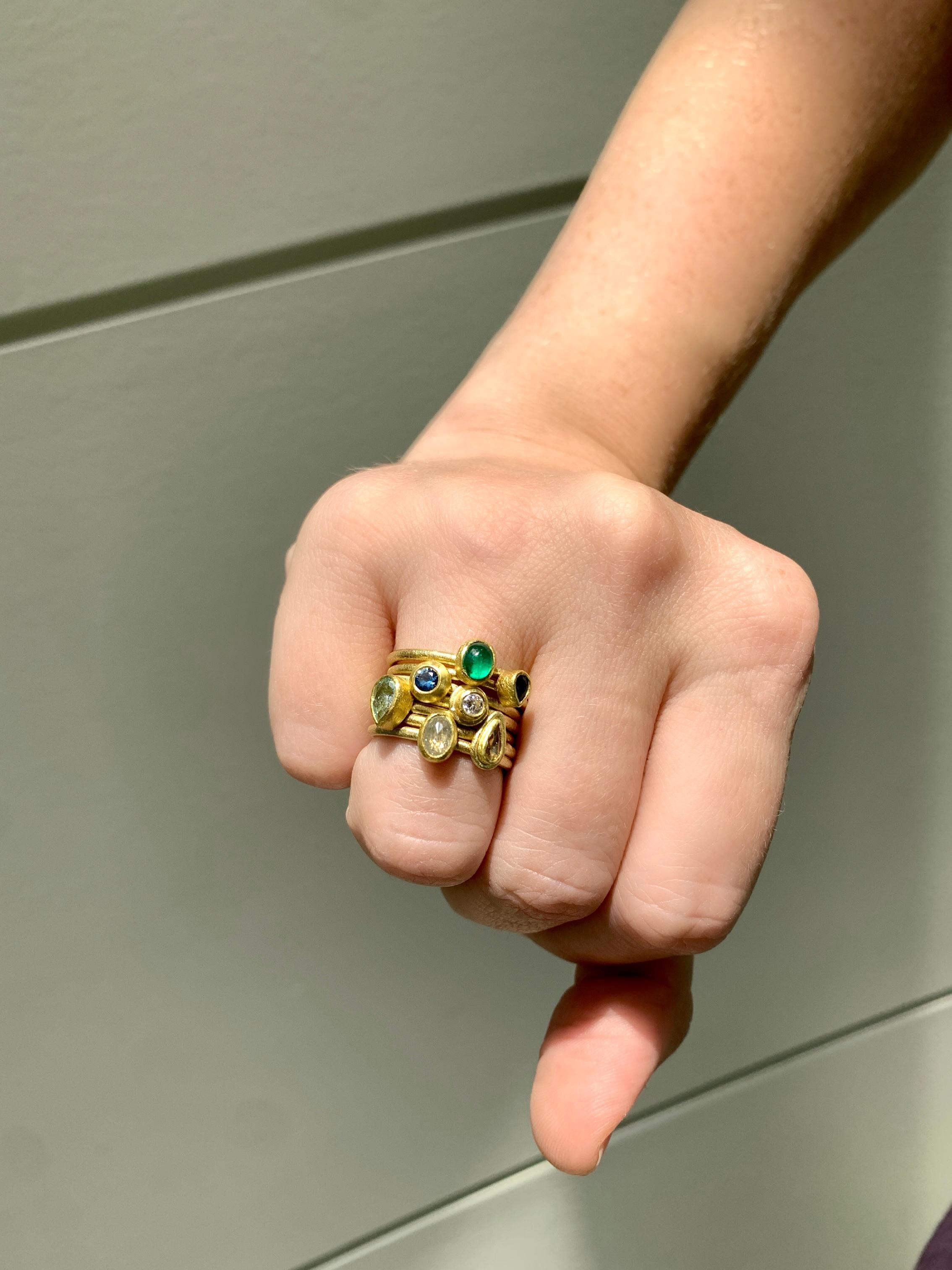 One-of-a-Kind Stacking Ring Set hand-fabricated by jewelry maker Petra Class featuring gorgeous bezel-set diamond, emerald, sapphire, and aquamarine gemstones (listed below: top to bottom) in signature-finished 22k yellow gold atop 18k yellow gold