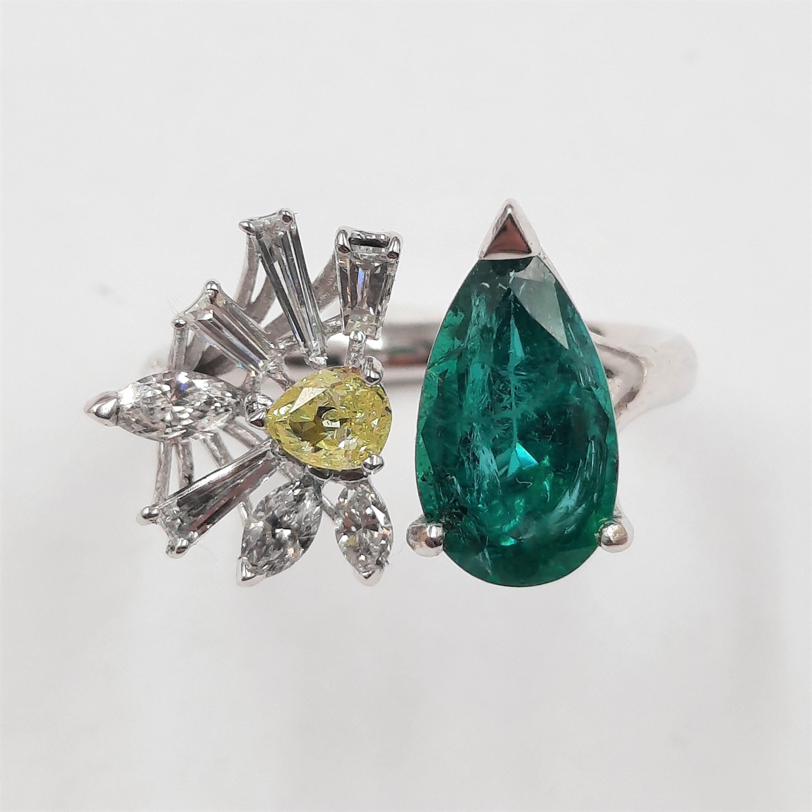 Elegant and original emerald (2.13 carats), fancy diamond (0.26 carats), tapered baguette diamond (0.27 carats),  marquise diamond (0.31 carats) and 18 carats white gold (4.20 grams) ring.  