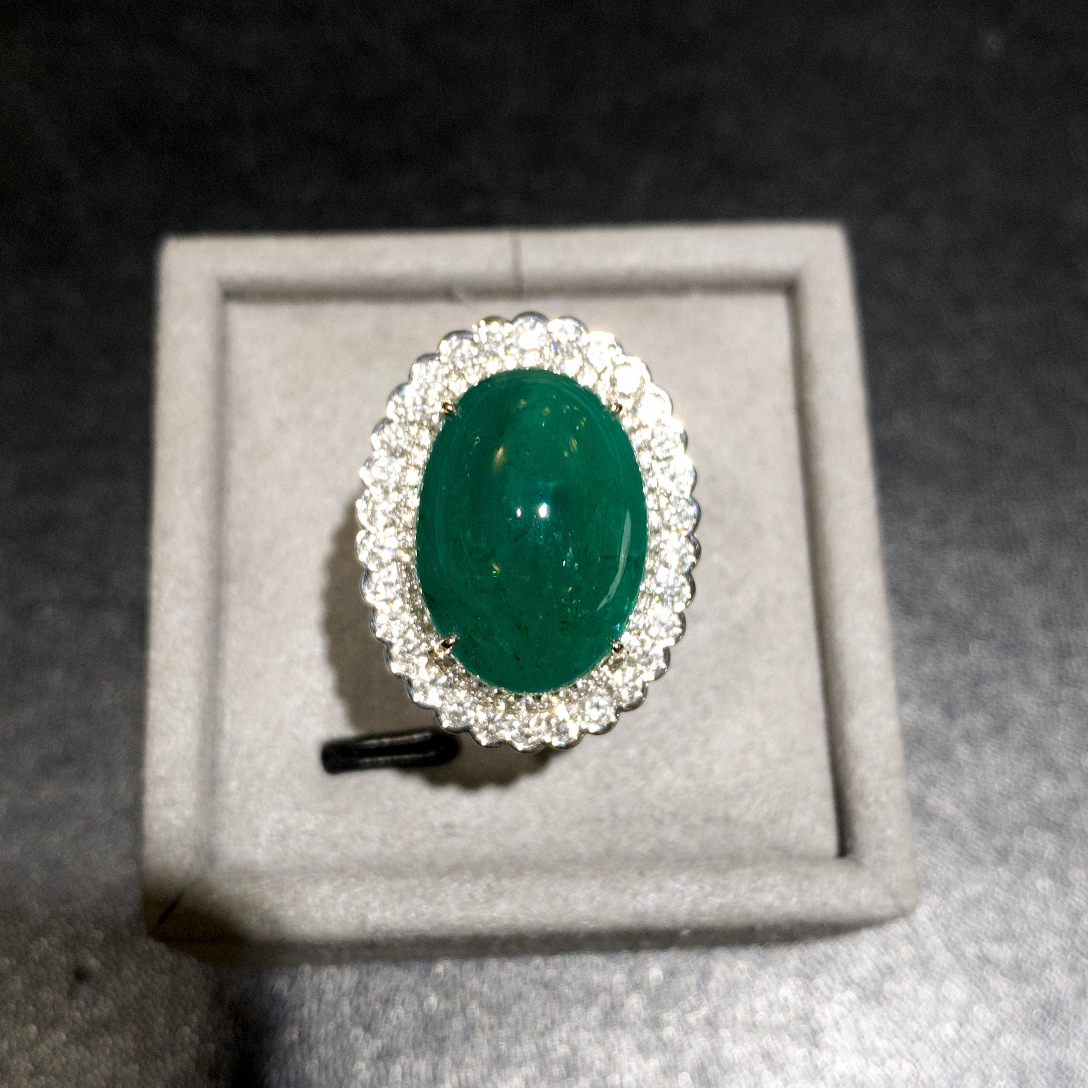 Emerald Cabochon 15.48Ct Muzo Coloor And Diamond Ring In 18K Gold 

Main Emerald weight is 15.48ct and has Minor Clarity Enhancement. The Colour of the Emerald is Vivid Green and is known in the trade as “Muzo Green”

Gemological testing revealed