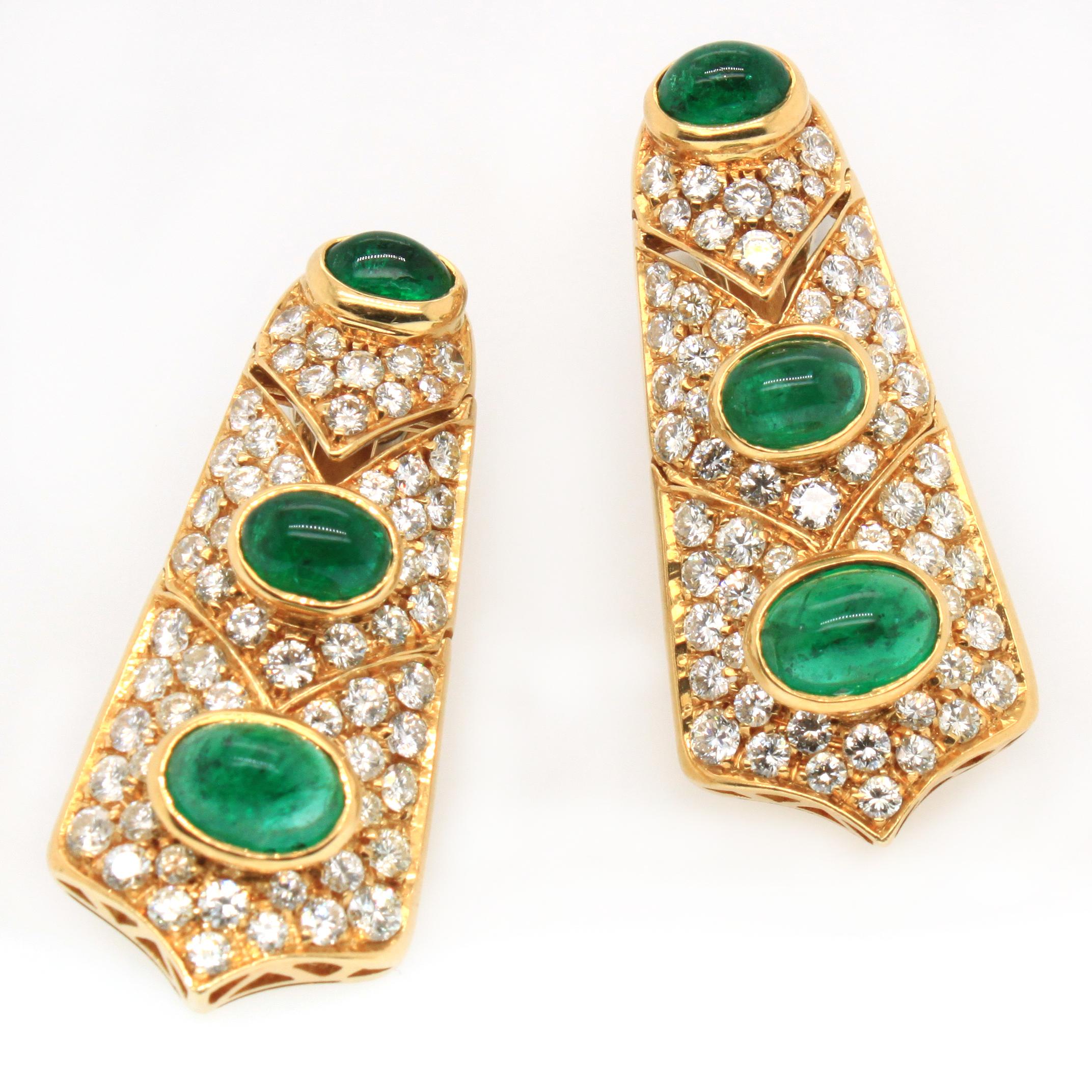 Emerald cabochon and round brilliant cut diamond earrings in 18k yellow gold. The earrings have three moving parts in an oriental/chevron design, each studded with an emerald cabochon and smaller diamonds. The emerald have a strong  and transparent