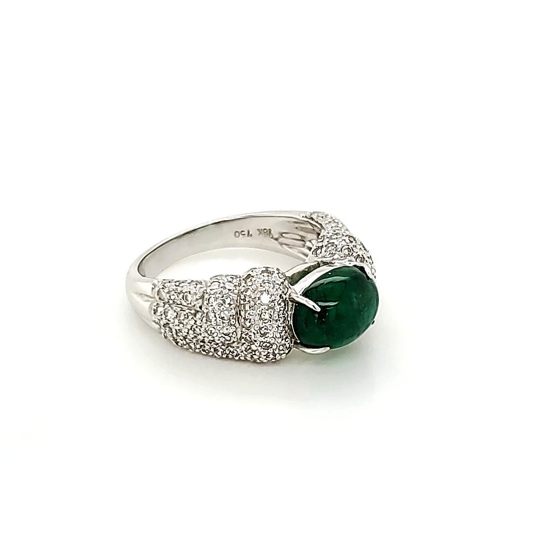 Emerald Cabochon And Diamond Ring:

A Vivid Green Cabochon Emerald weighing 2.13 carat, with embellishment of 136 White Diamonds on the shank weighing 0.94 carat. Although a simple design, the regal look of the Emerald makes the ring ever so