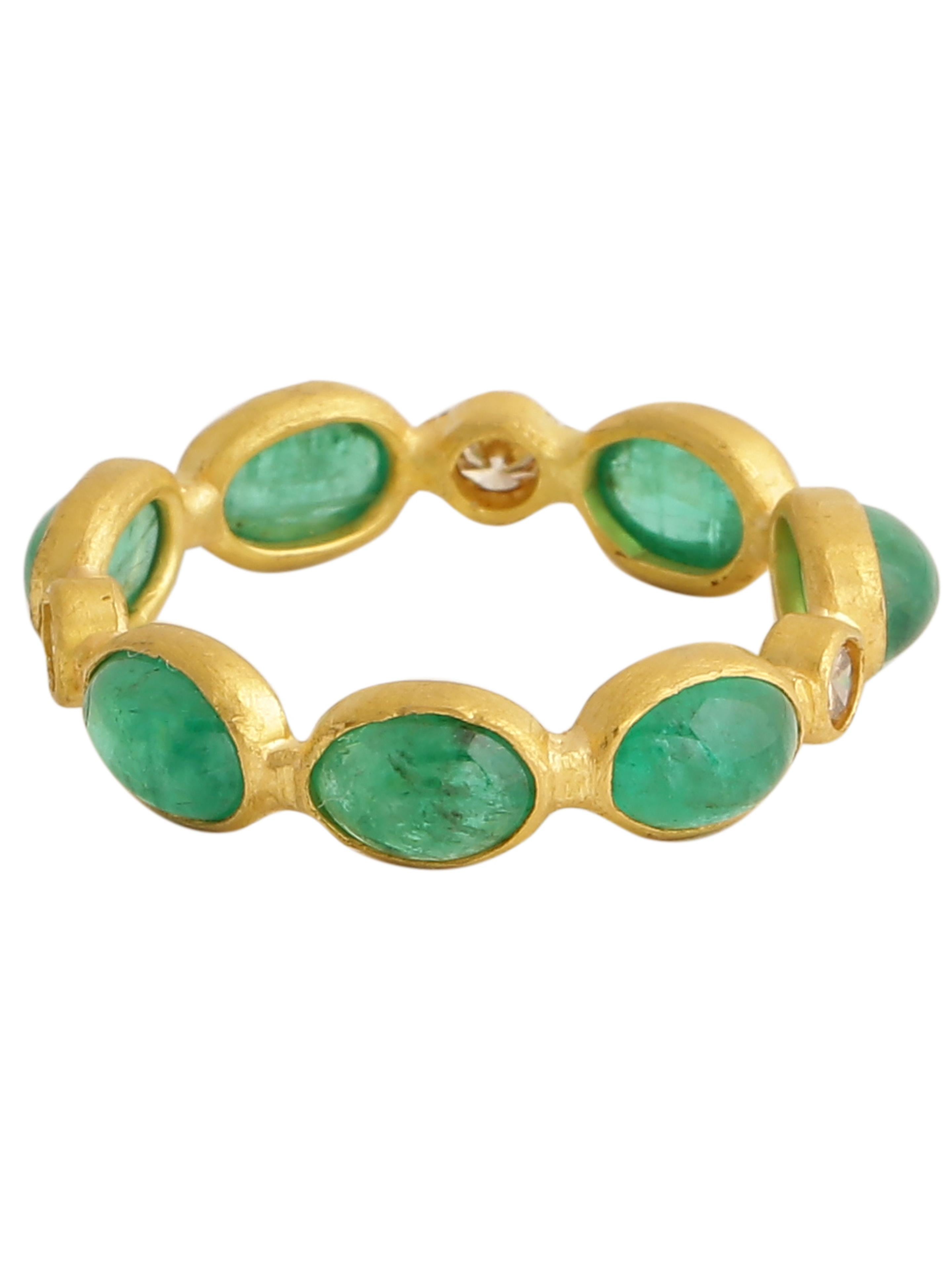This beautifully handcrafted eternity band  in 22kt matte finish gold is adorned with natural emerald cabochons and diamonds. The ring has been made by hand by extremely talented local artisans from Jaipur- a city known world over for its fine