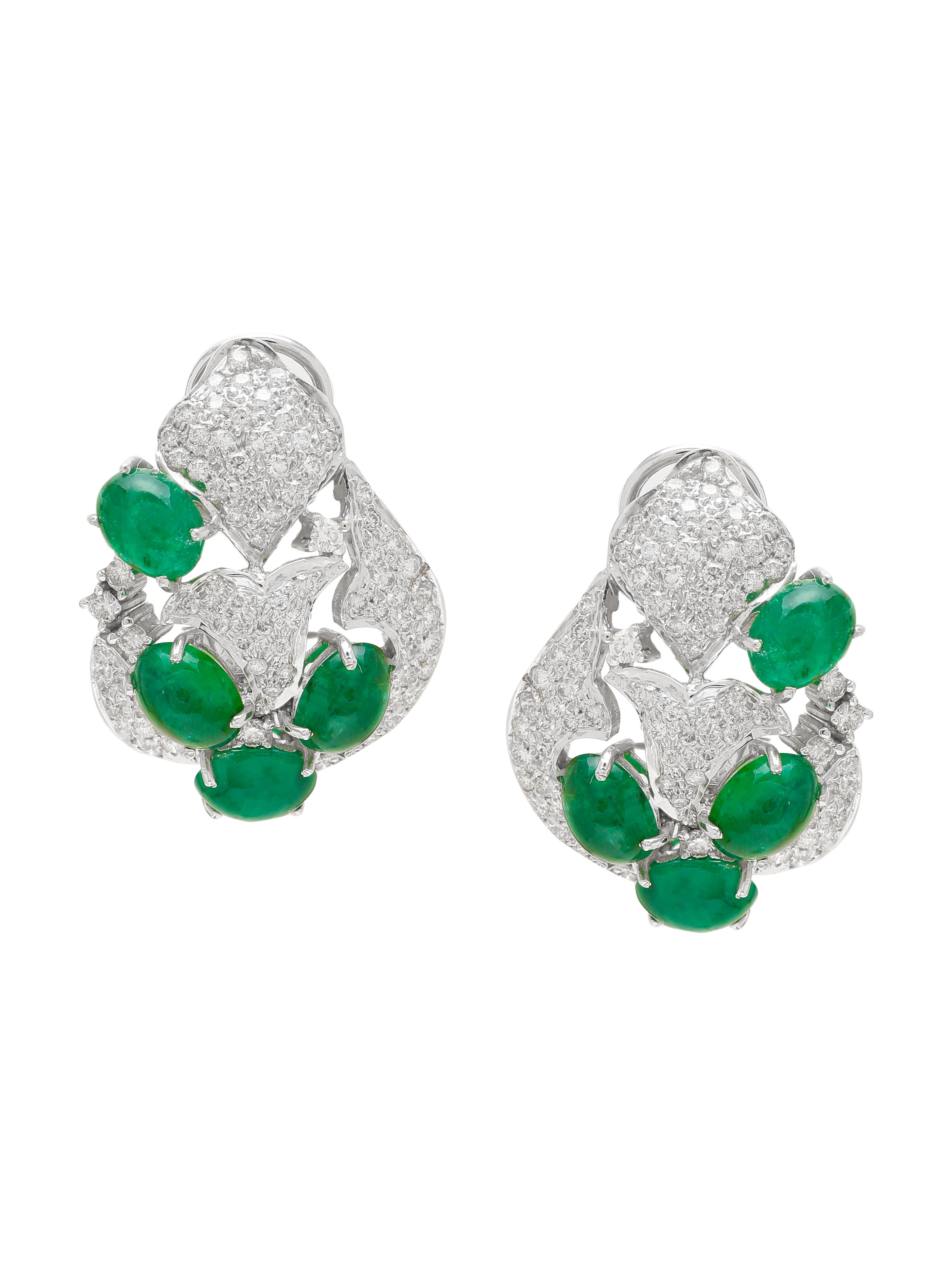A pair of pretty Stud Earrings with Zambian Oval Emerald Cabochons and Small Round Diamonds set all around. The earrings are beautifully made in 18K White Gold. We have used really good quality Diamonds. With the Emeralds and Shiney Diamonds the