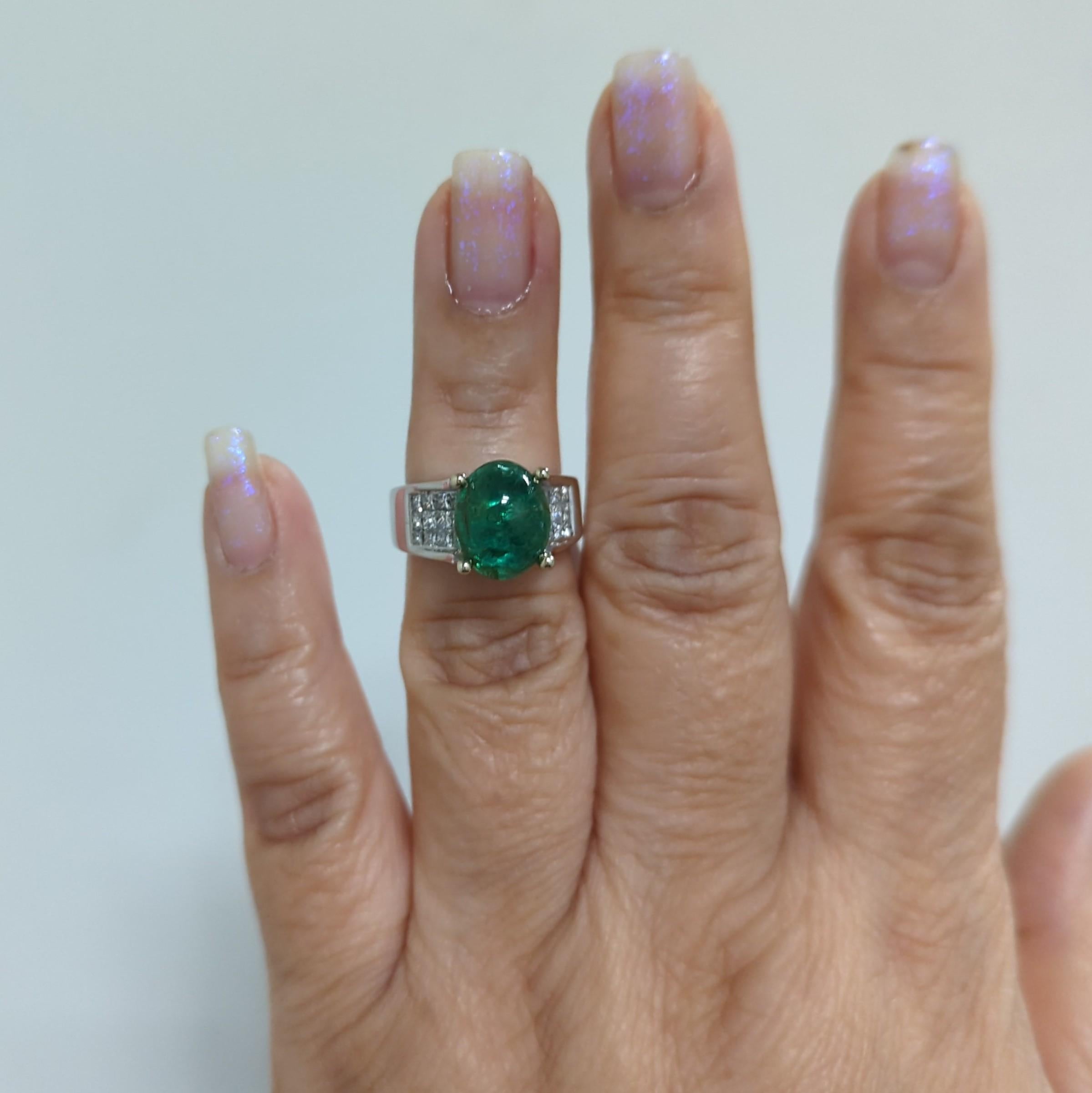 Beautiful 4.24 ct. emerald oval cabochon with 1.00 ct. good quality white diamond princess cuts.  Handmade in 18k white gold.  Ring size 6.