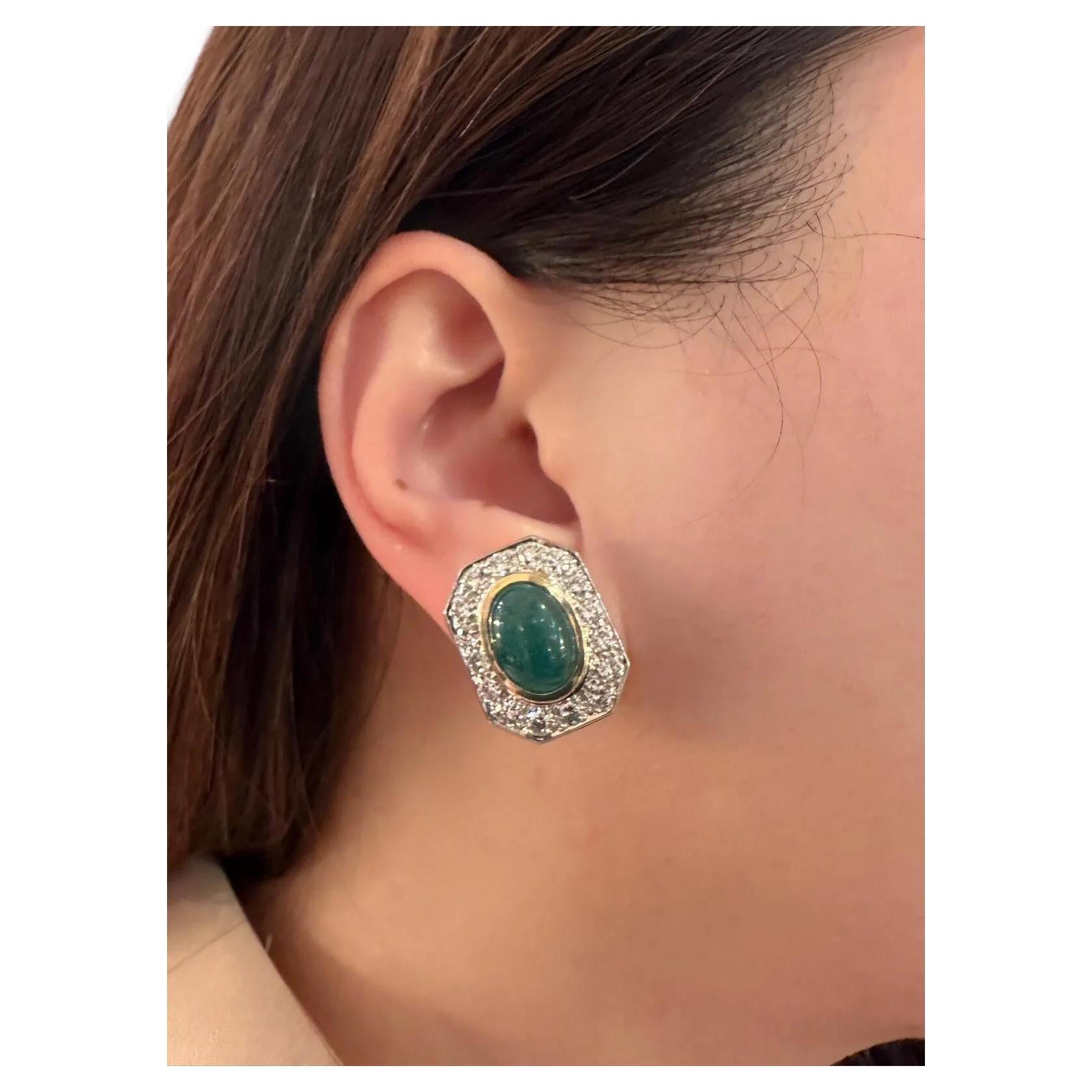 Emerald Cabochon and Diamond Statement Earrings in 18k Yellow Gold

Diamond and Emerald Earrings feature Oval-shaped Emerald Cabochons surrounded by Round Brilliant Cut Diamonds set in 18k Yellow Gold. The earrings are secured by clip on