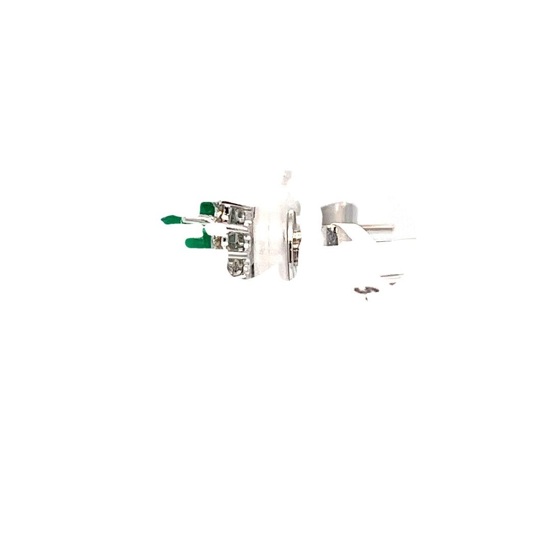 Gorgeous 18 karat white gold halo earrings featuring 2 oval cabochon emeralds totaling approximately 3.10 carats surrounded by 32 round brilliant cut diamonds of VS/SI clarity and G/H color totaling 0.30 carats. Pierced post with friction back.
