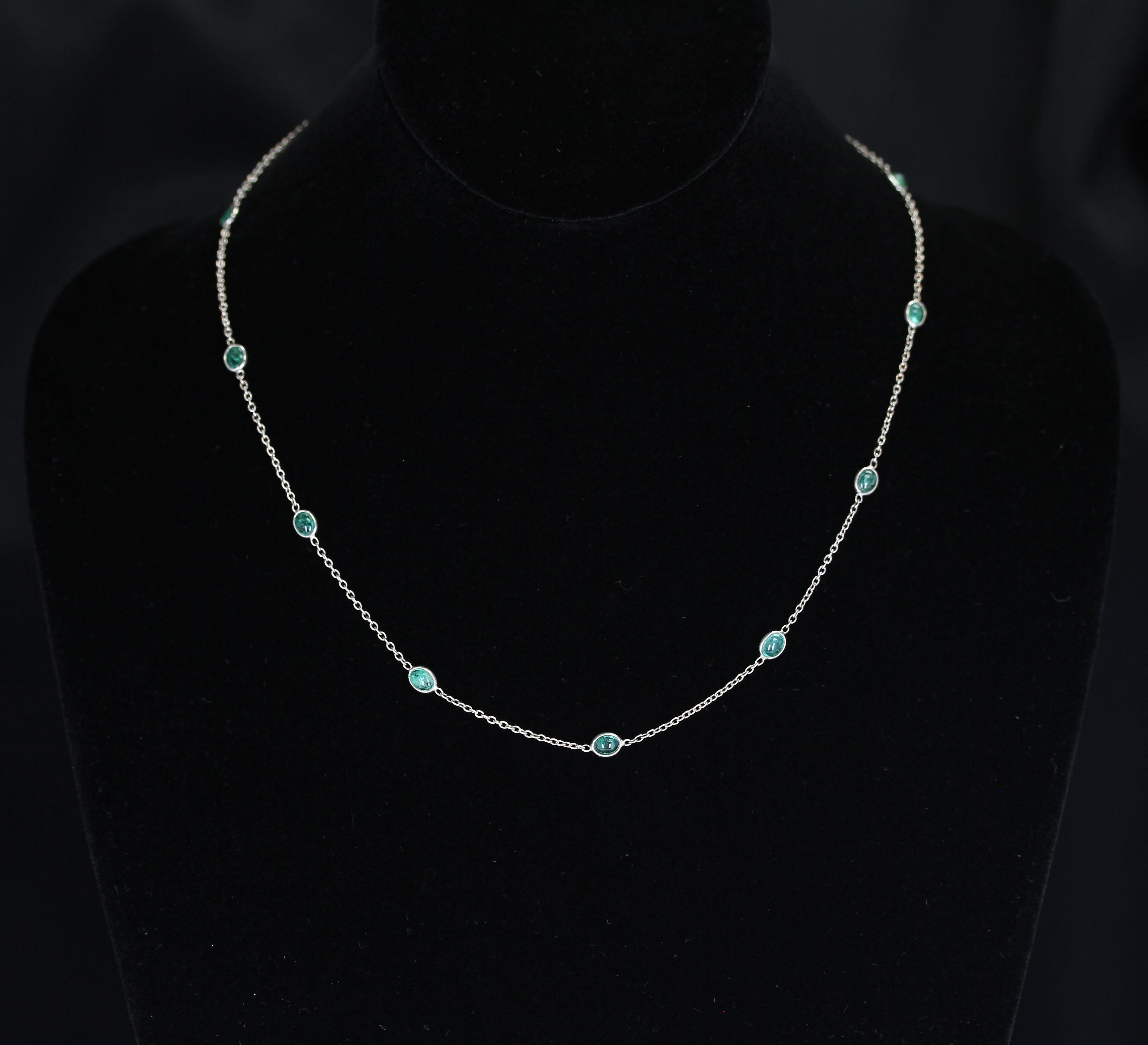 A dainty and everyday-wear Emerald cabochon necklace in silver. Weight: Approximately 15 carats. Length: 18” 