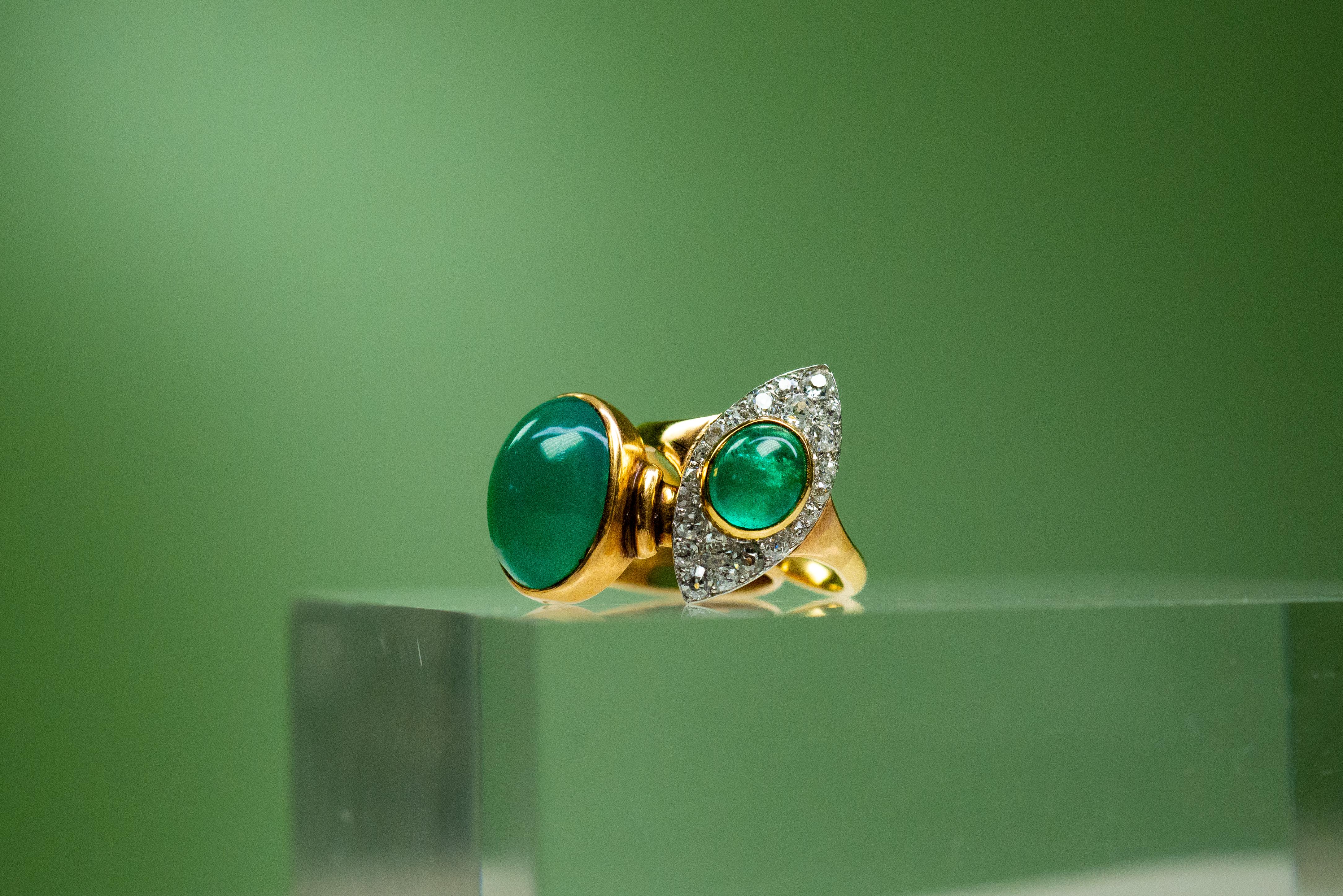 Handmade in our atelier, this vintage-style ring is truly special. The unique pale green emerald cabochon at its centre is a timeless oval shape and weighs in at 1.17 carats. Around its edges is a sparkling cluster of white diamonds in round old cut