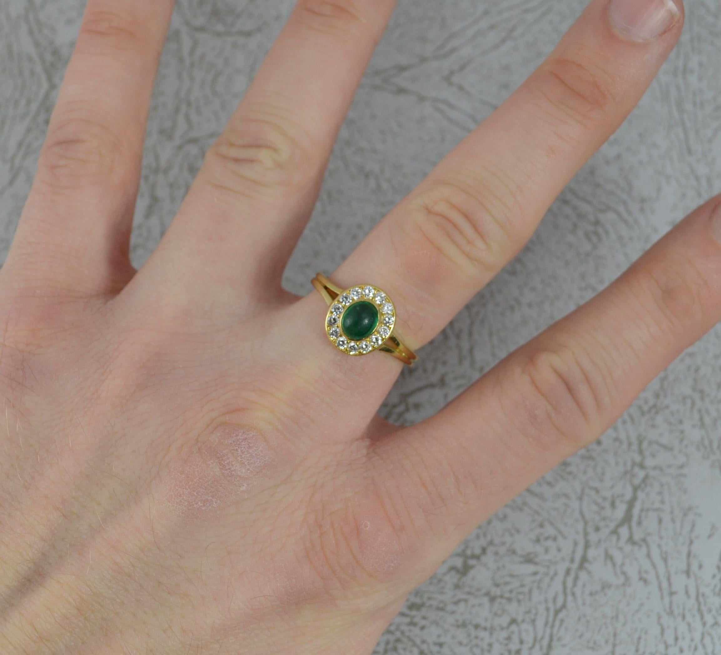 A fantastic vintage cluster ring.
Solid 18 carat yellow gold example.
Designed with a 5.2mm x 6.2mm oval shaped emerald cabochon to centre. Surrounding are fourteen natural round brilliant cut diamonds, vs1 clarity, e-f colour.
11mm x 9.9mm cluster