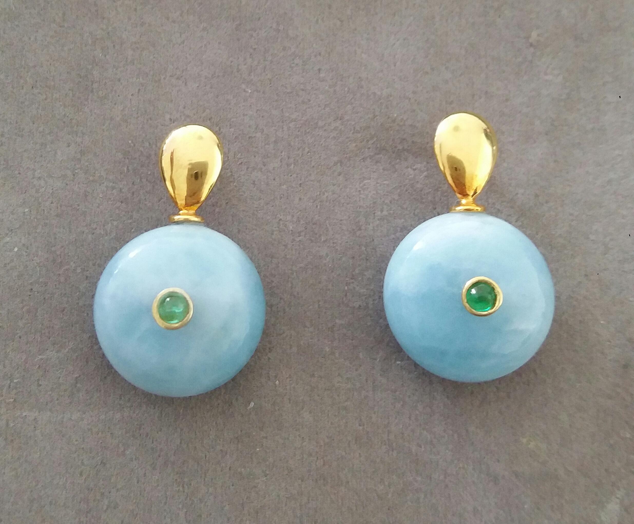 Simple chic stud earrings with a pair of Flat Drop shape 14 Kt. yellow gold tops and in the lower parts 2 Round Plain Wheel Shape Aquamarines  16 mm .in diameter with a small round Emeralds cabs in the center
In 1978 our workshop started in Italy to