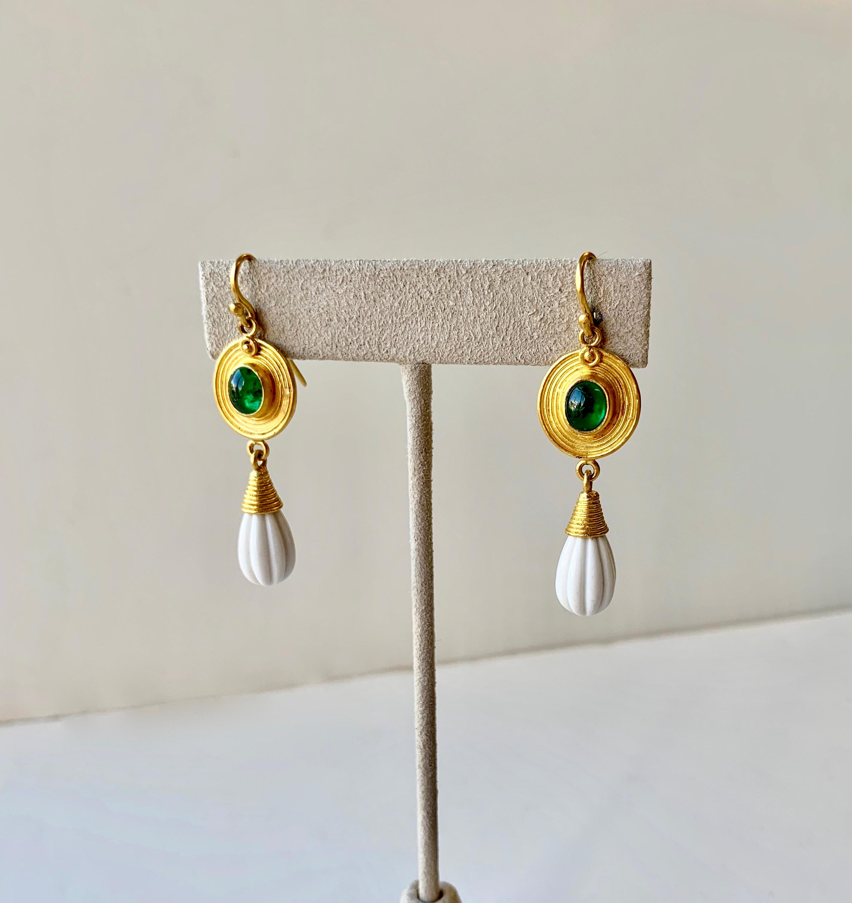 Oval Emerald cabochon earrings with carved Cachalong ( white Agathe) dangles in the style of Roman antiquity in 22 Karat gold and 20 Karat gold.
Hand made in New York, one of a kind.