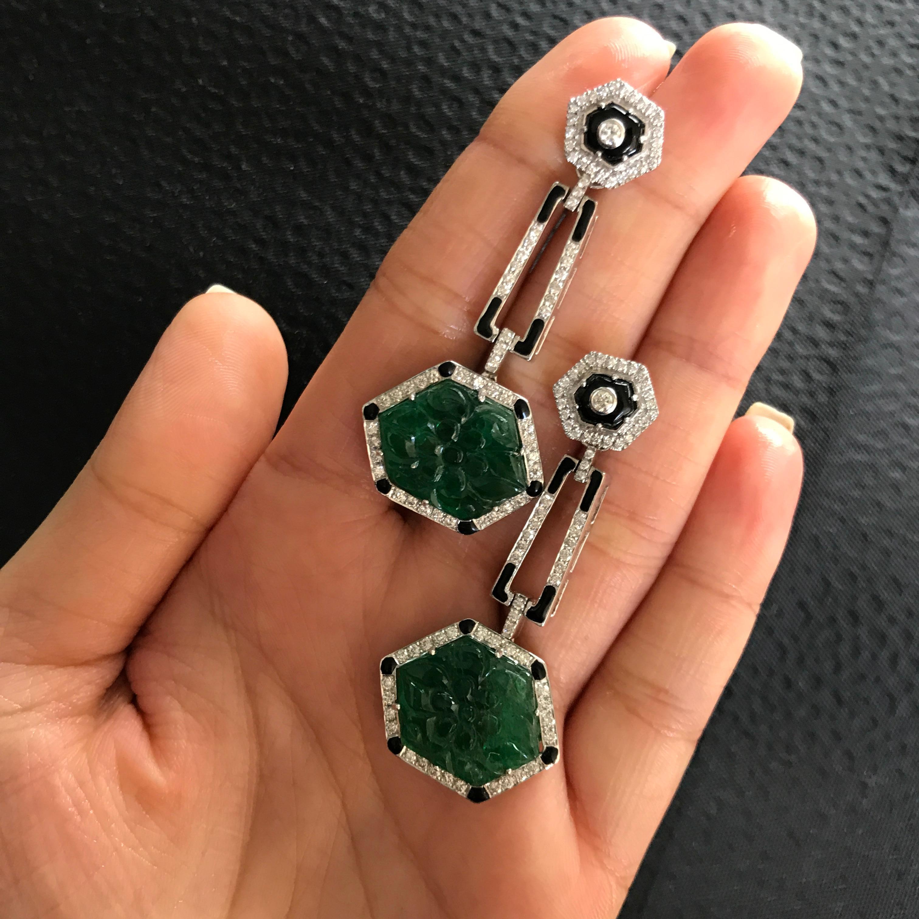 A pair of very unique, art-deco looking Zambian Emerald dangling earrings with push-pull backing,  with White Diamonds and enamel work all set in 18K white gold.   

Stone Details:  
Stone: Zambian Emerald  
Carat Weight: 2pcs / 24.96 Carats