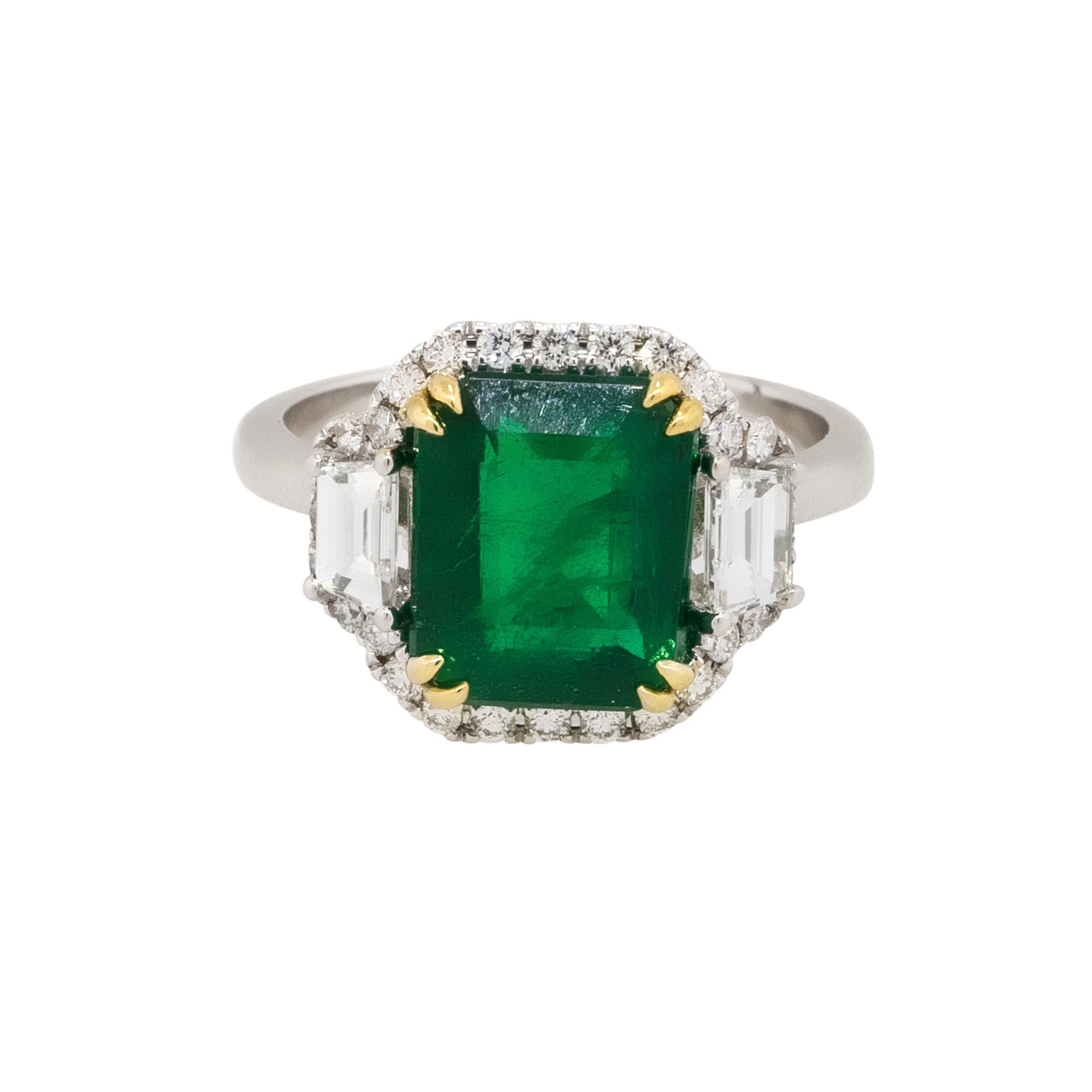 Material: 18k white gold and 18k yellow gold 
Diamond Details: Approx. 0.85ctw of trapezoid and round brilliant Diamonds. Diamonds are G/H in color and VS in clarity
Gemstone Details: Approx. 4.11ctw Emerald gemstone center
Ring Size: 7
Total