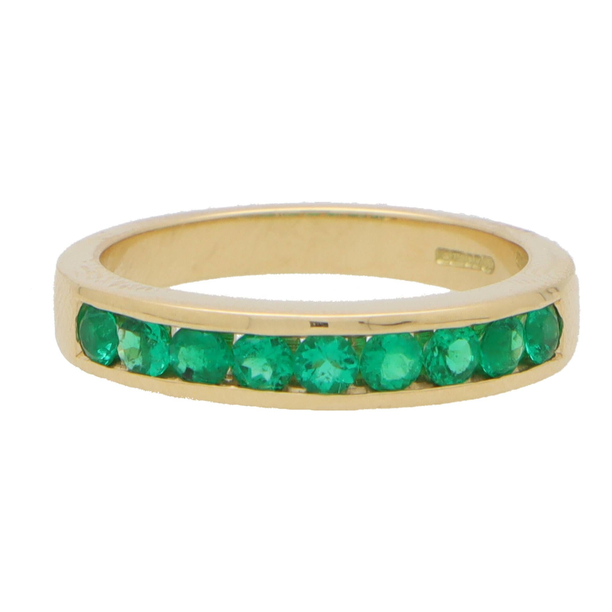 A beautiful emerald half eternity ring set in 18k yellow gold.

The ring is composed of 9 round cut emerald stones altogether which have been perfectly matched it colour and lustre. All the stones are securely bezel set within a 4mm yellow gold