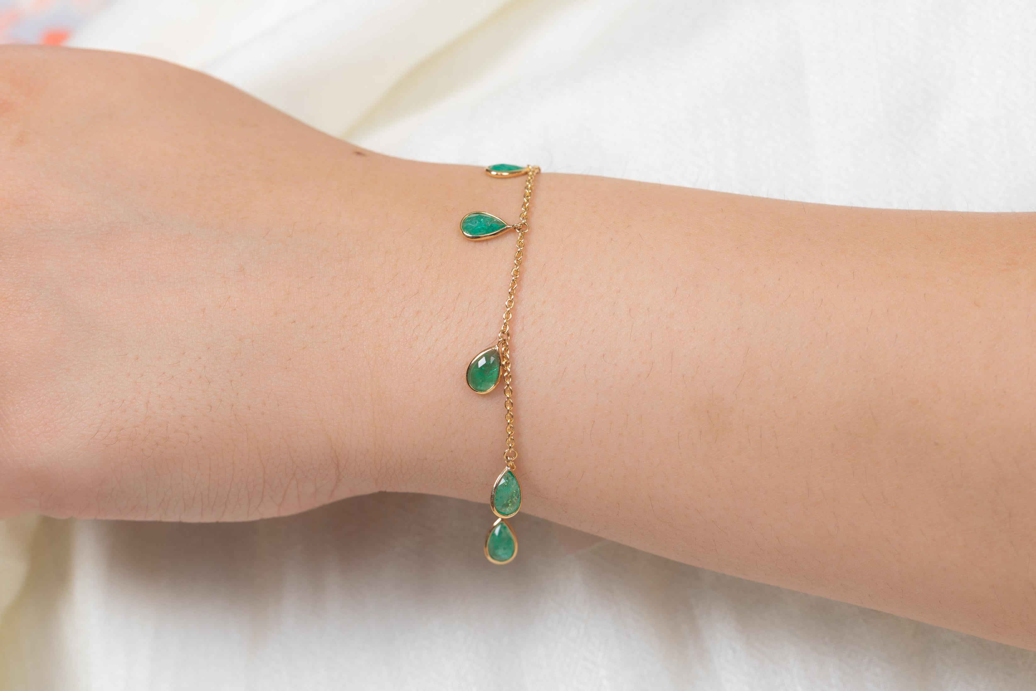 This Emerald Charm Chain Bracelet in 18K gold showcases 7 endlessly sparkling natural emerald, weighing 3.5 carat. It measures 7.25 inches long in length. 
Emerald enhances intellectual capacity of the person.
Designed with perfect pear cut dangling