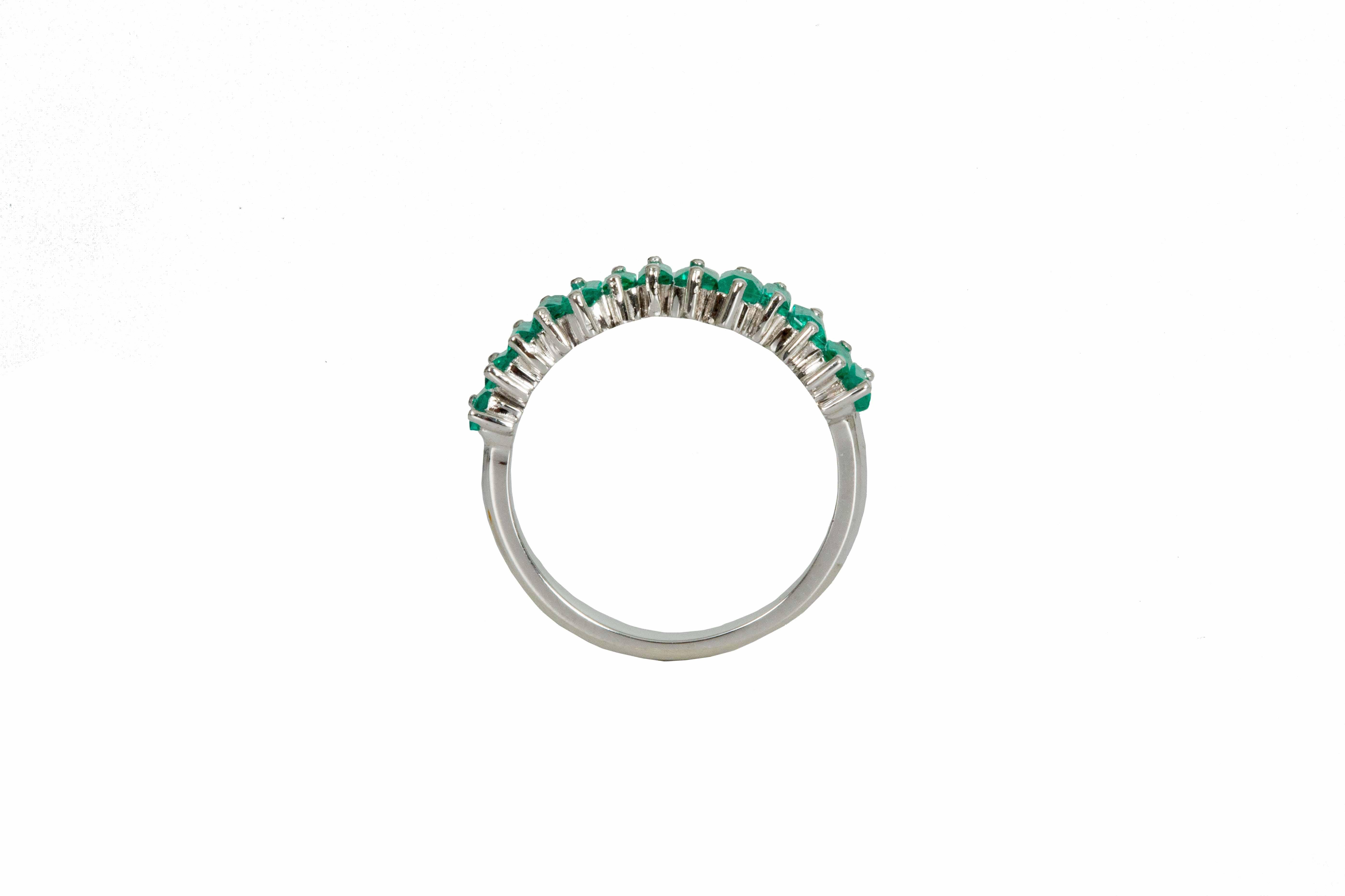 18 carat white gold band with 14 baguette cut Colombian emeralds weighing 1.40 carats total. Our Emeralds are hand selected by our team of experts and carefully set unevenly to create a fascinating composition. A twist on tradition this 