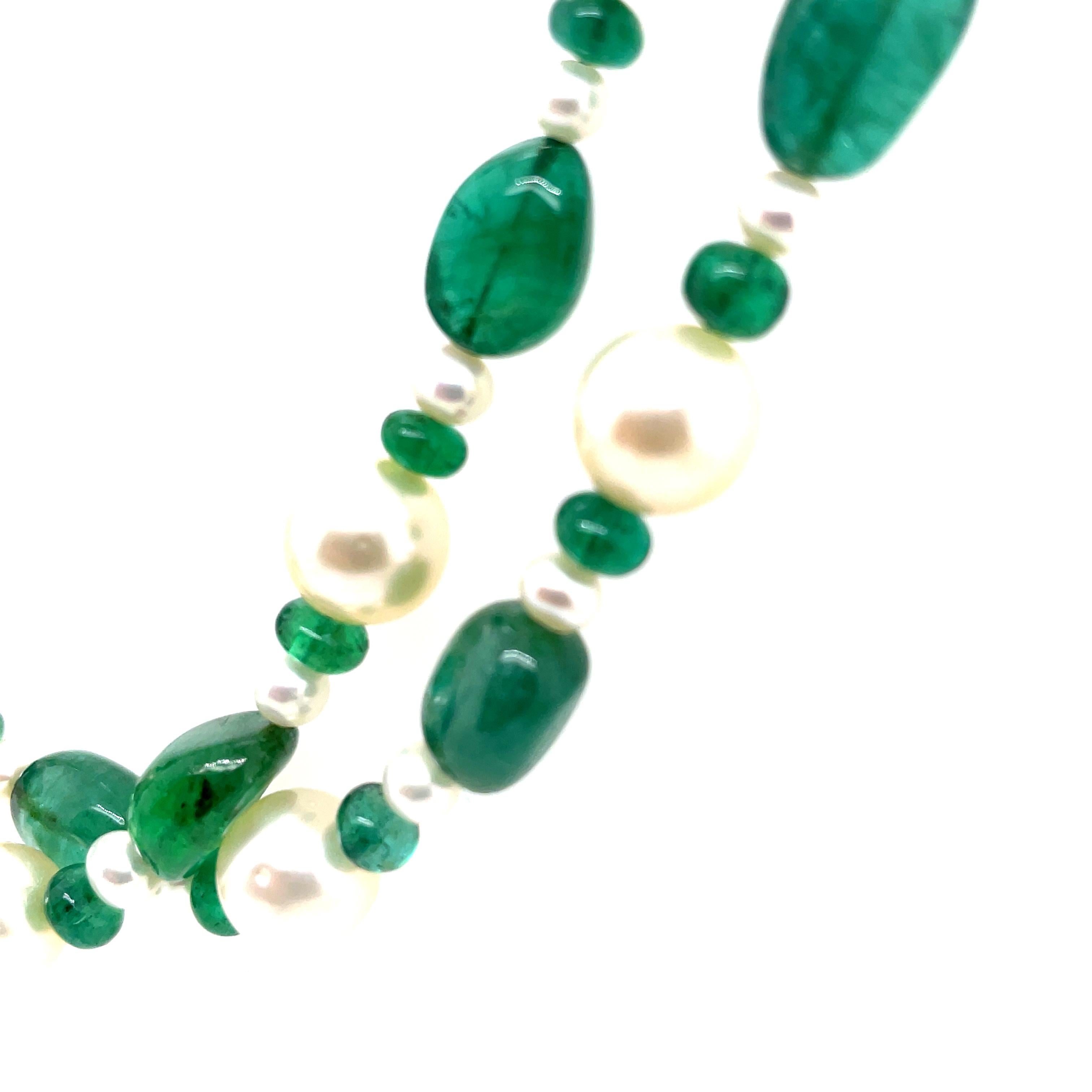 This alluring piece features 73 Zambian emerald beads totaling 144.96 carats, renowned for their deep, verdant hue and exceptional clarity. 

Complemented by 74 South Sea pearls, this necklace is anchored with a refined 18k white gold