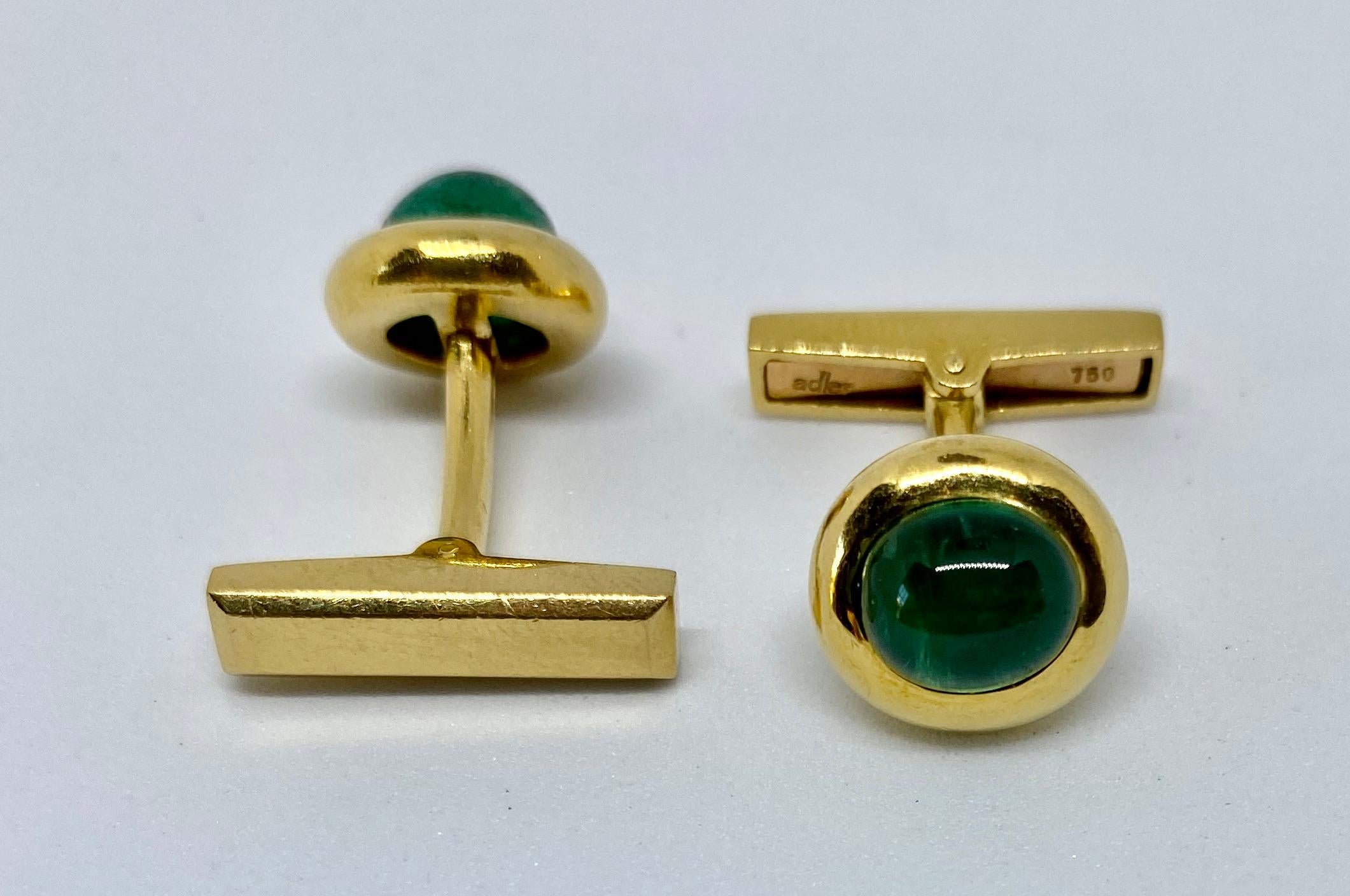 Established in the 19th Century and best known for its use of the finest gemstones, the Geneva-based Maison Adler produced these tasteful cufflinks featuring two luminous, cabochon-cut emeralds set in heavy, 18K yellow gold. The natural emerald