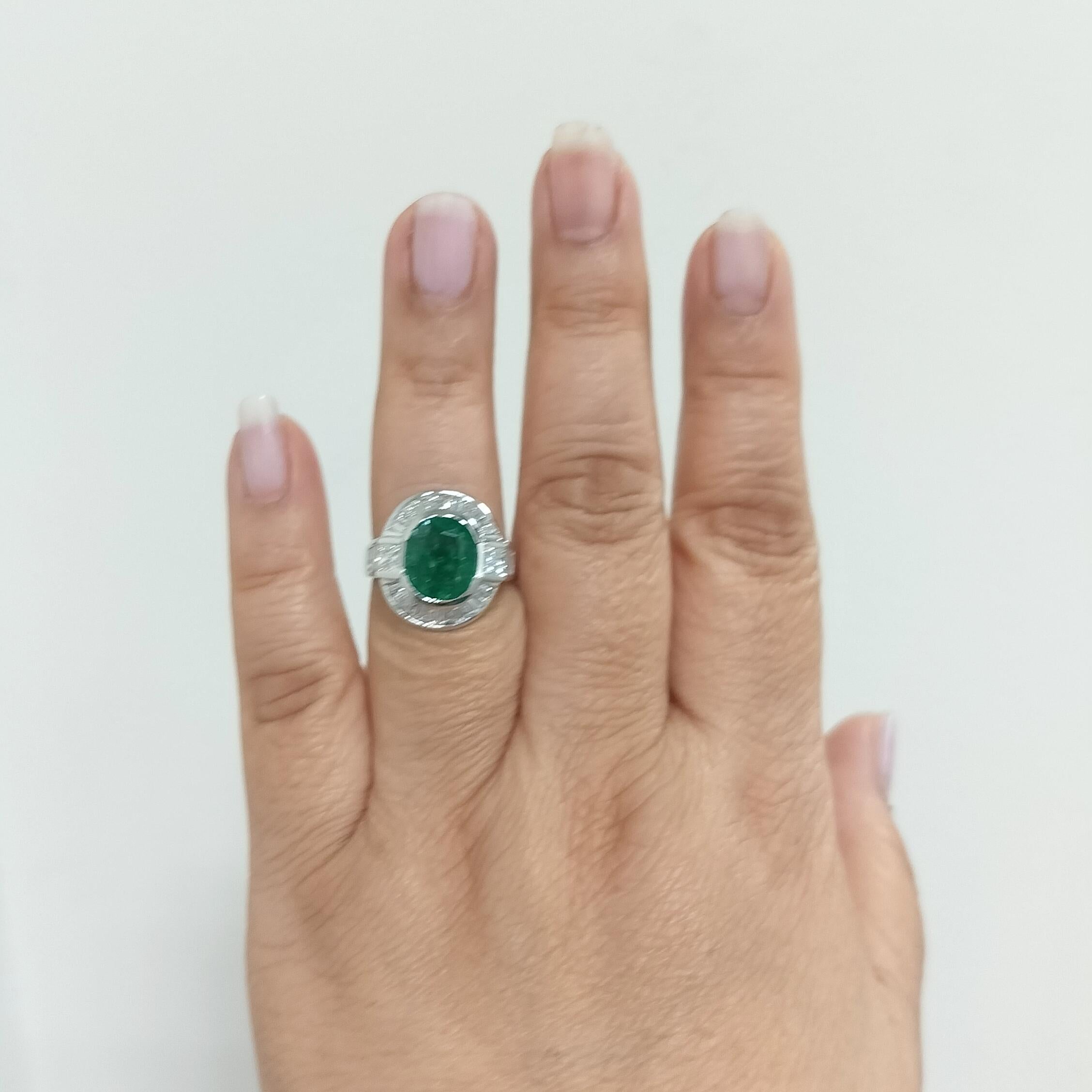 Beautiful bright green 4.07 ct. emerald cushion with good quality, white, and bright diamond baguettes and square cuts.  Handmade in 18k white gold.  Ring size 7.