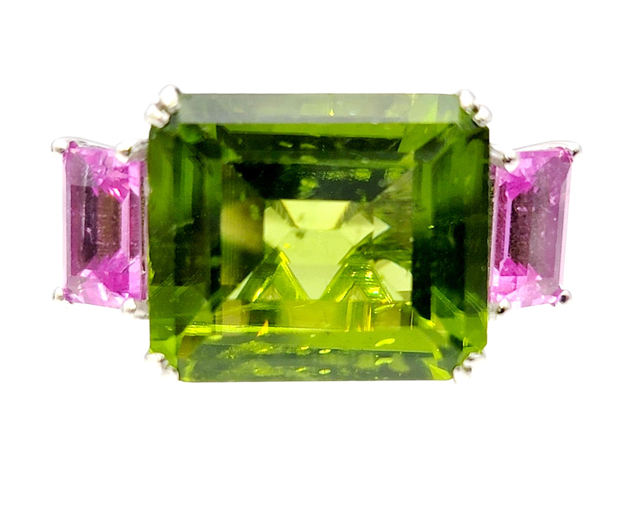 Ring size: 7.5

Bright, bold and beautiful peridot and pink sapphire 3 stone cocktail ring with diamond accents. This ultra contemporary piece is certainly eye-catching with its impressive size and vibrant color and absolutely pops on the finger.