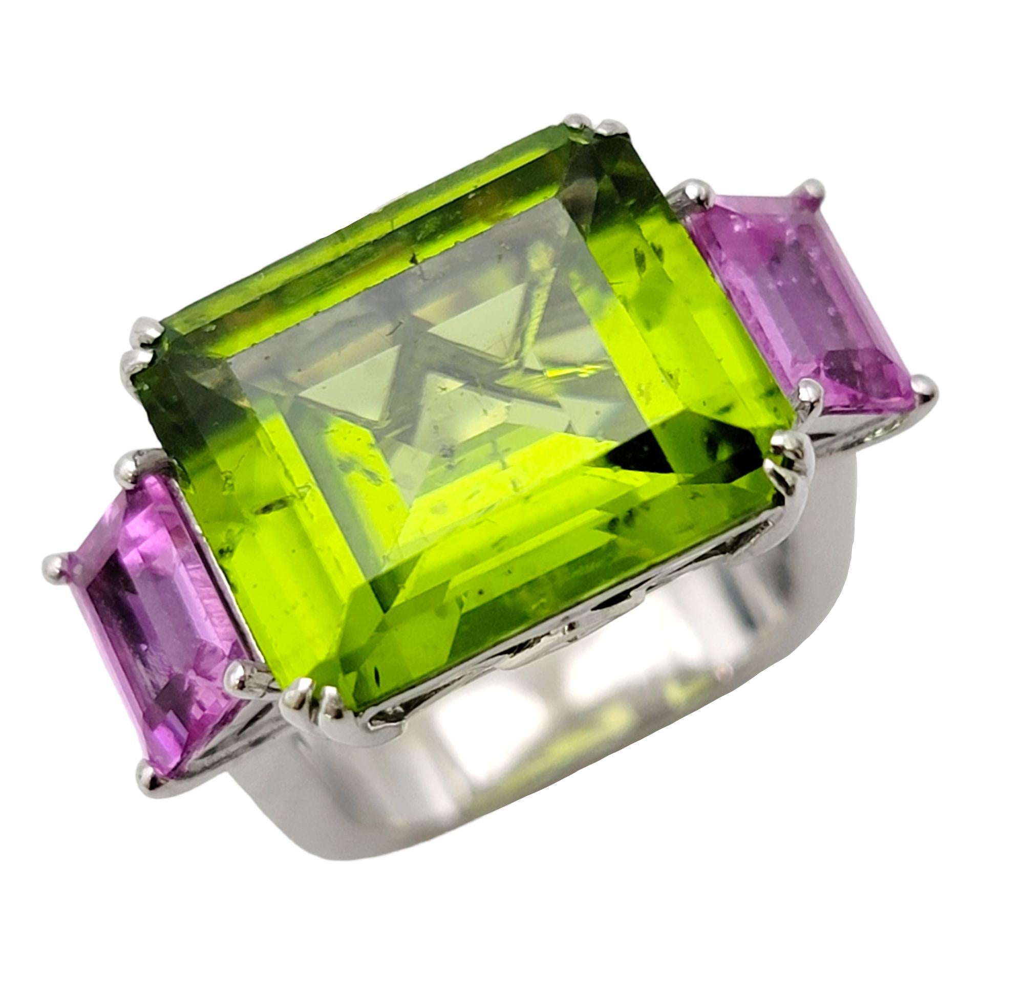 Contemporary Emerald Cut 11.42 Carat Peridot, Pink Sapphire and Diamond Euro Shank Band Ring For Sale
