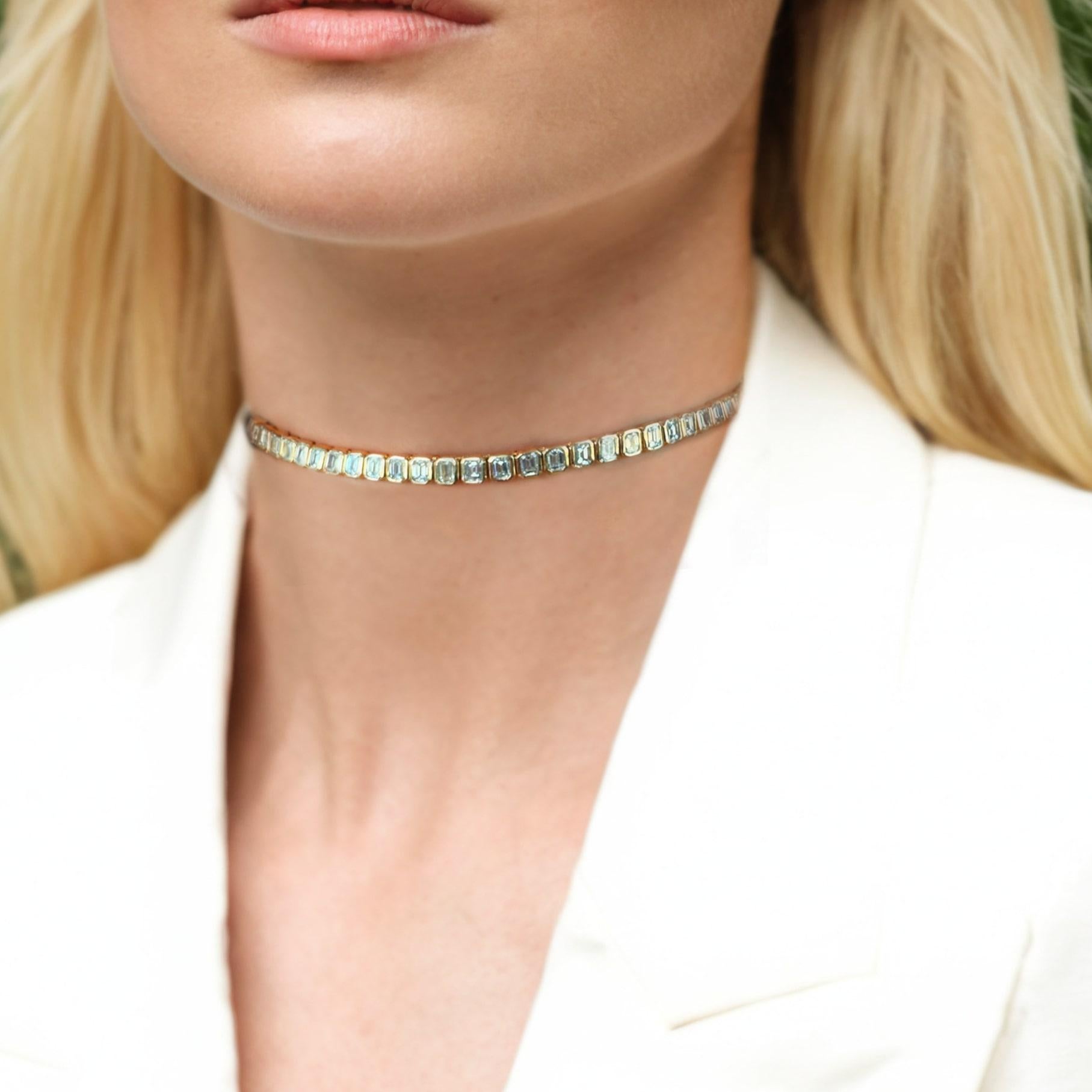 Elevate your everyday elegance with this stunning Diamond . Featuring a seamless row of emerald-cut cubic zirconia stones set in rich 14K yellow gold, this necklace blends timeless glamour with modern sophistication. Its bold yet refined design