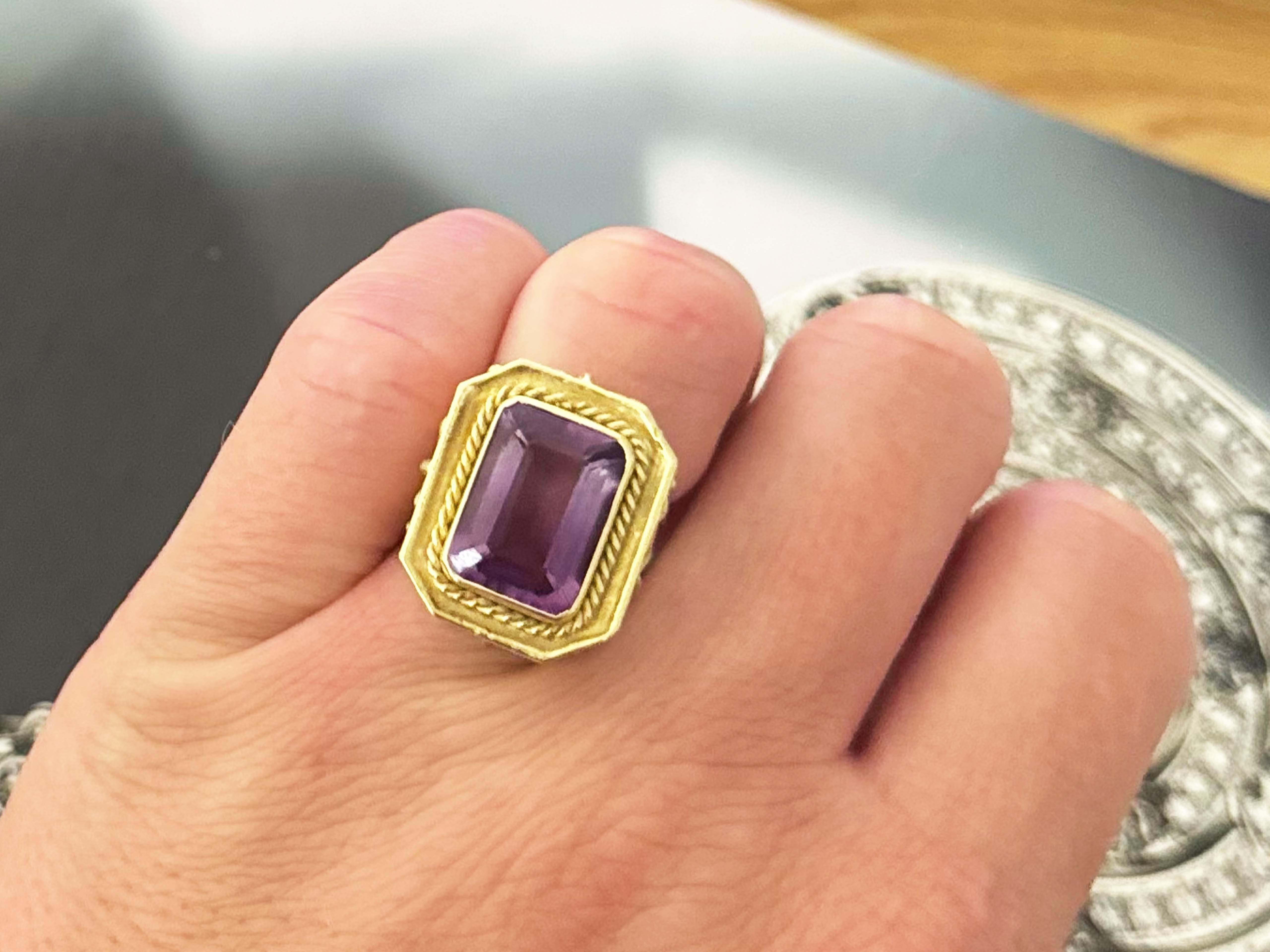 Item Specifications:

Metal: 18K Yellow Gold

Ring Size: 6 (resizing available for a fee)

Total Weight: 10.6 Grams

Ring Height: 22 mm tall

Gemstone Specifications:

Gemstone: 1 emerald cut purple amethyst

Amethyst Measurement: 15 mm x 11 mm x
