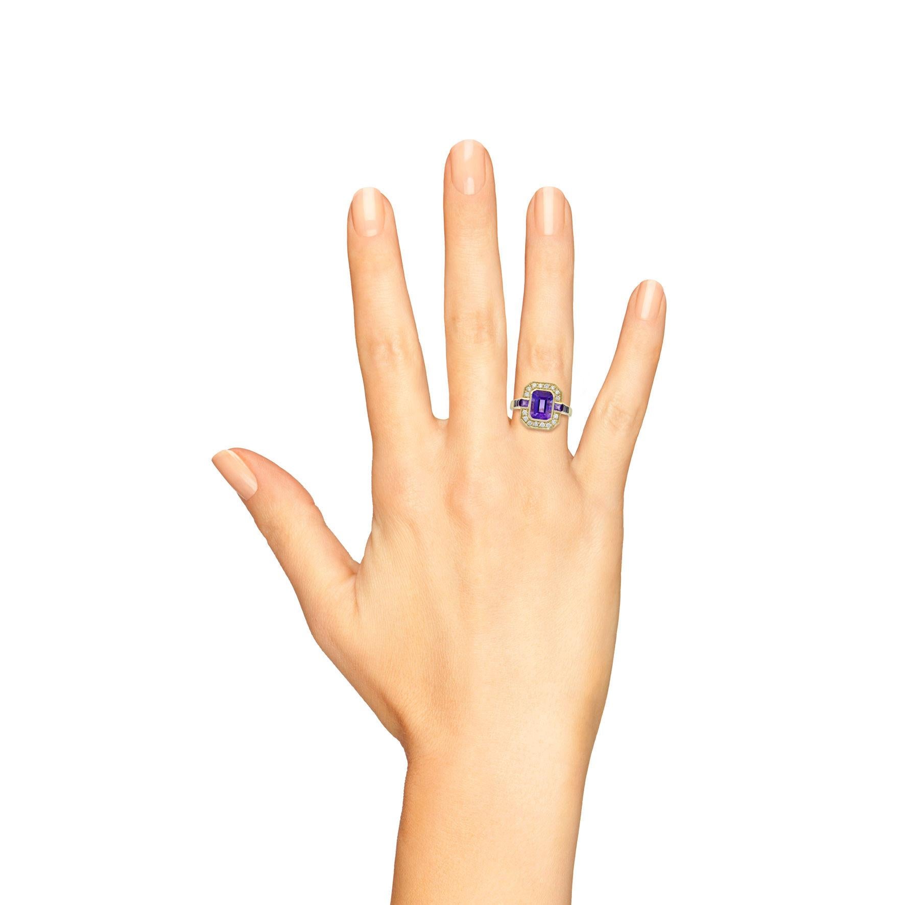 A chic emerald-cut amethyst is presented in classic Art Deco style. The glorious gemstone radiates from within a sparkling halo of bright white round brilliant cut diamonds, leading to a slightly flared diamond on the shoulder all set in 9k yellow