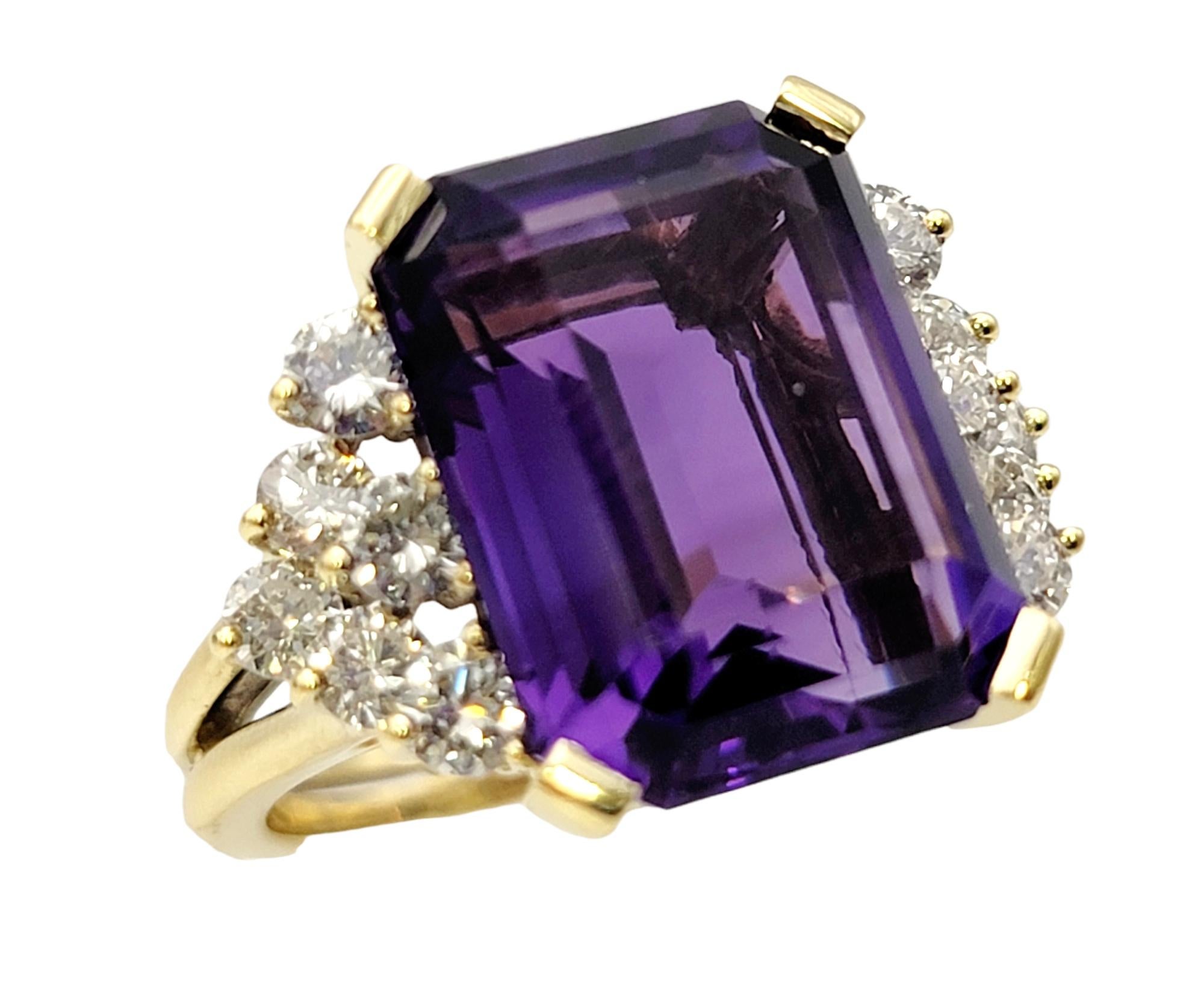 Ring size: 6.75

Breathtaking amethyst and diamond ring. The vibrant purple hue of the emerald cut amethyst pops against the icy white diamonds on either side, while the split yellow gold shank adds a unique detail to the piece. The elongated stone