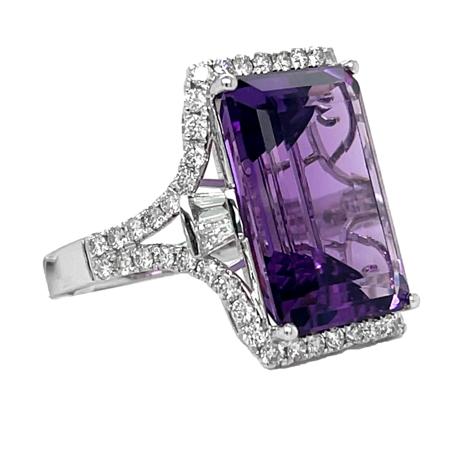 This stunning Statement ring has a AAA quality emerald cut African Amethyst with 4 prong setting in 14 karat white gold. There are 52 shimmering brilliant cut round diamonds and 4 baguette diamonds on the shank. This beautiful ring will be the talk