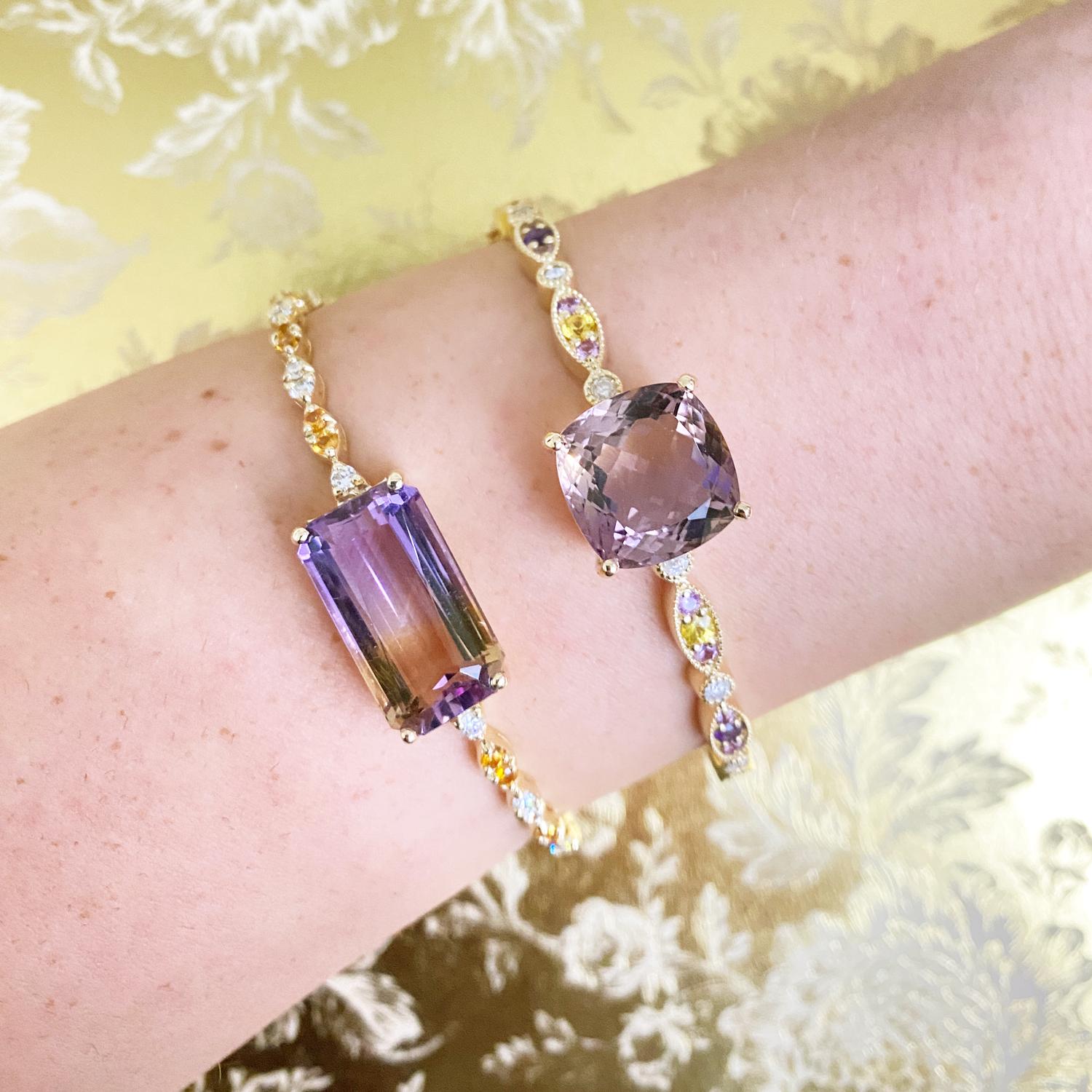 14K Yellow Gold

Center Stone: 12.68 Carats Total Weight of an Emerald Cut Ametrine

0.45 Carats Total Weight of Round Yellow Sapphires 

0.45 Carats Total Weight of Round Brilliant White Diamonds

Color: H-I / Clarity: SI 

Fine one-of-a-kind