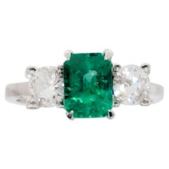 Emerald Cut and White Diamond Three-Stone Ring