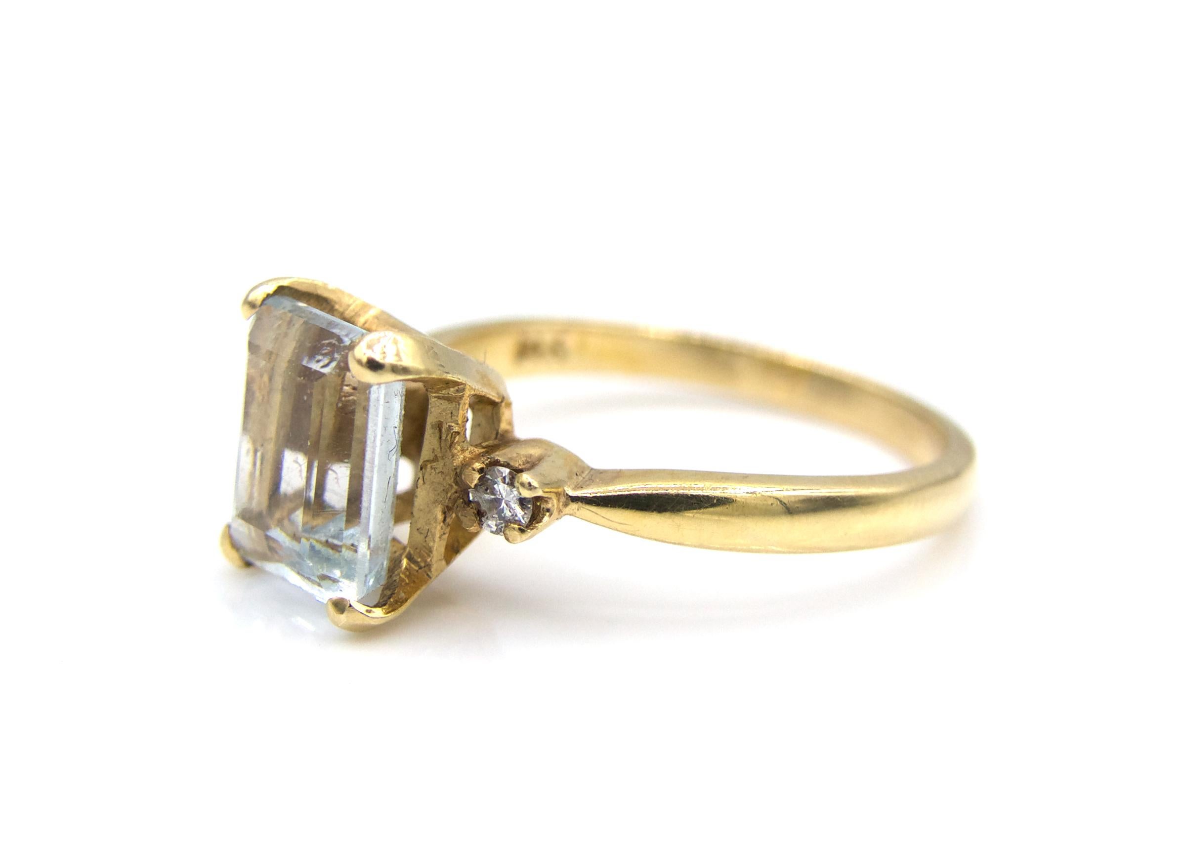This classic and beautiful 14K Yellow Gold ring flaunts a 3 Carat Emerald Cut Aquamarine center stone with round cut diamonds on each of its sides. 

3.4 grams 

Size 6.25

Sizable