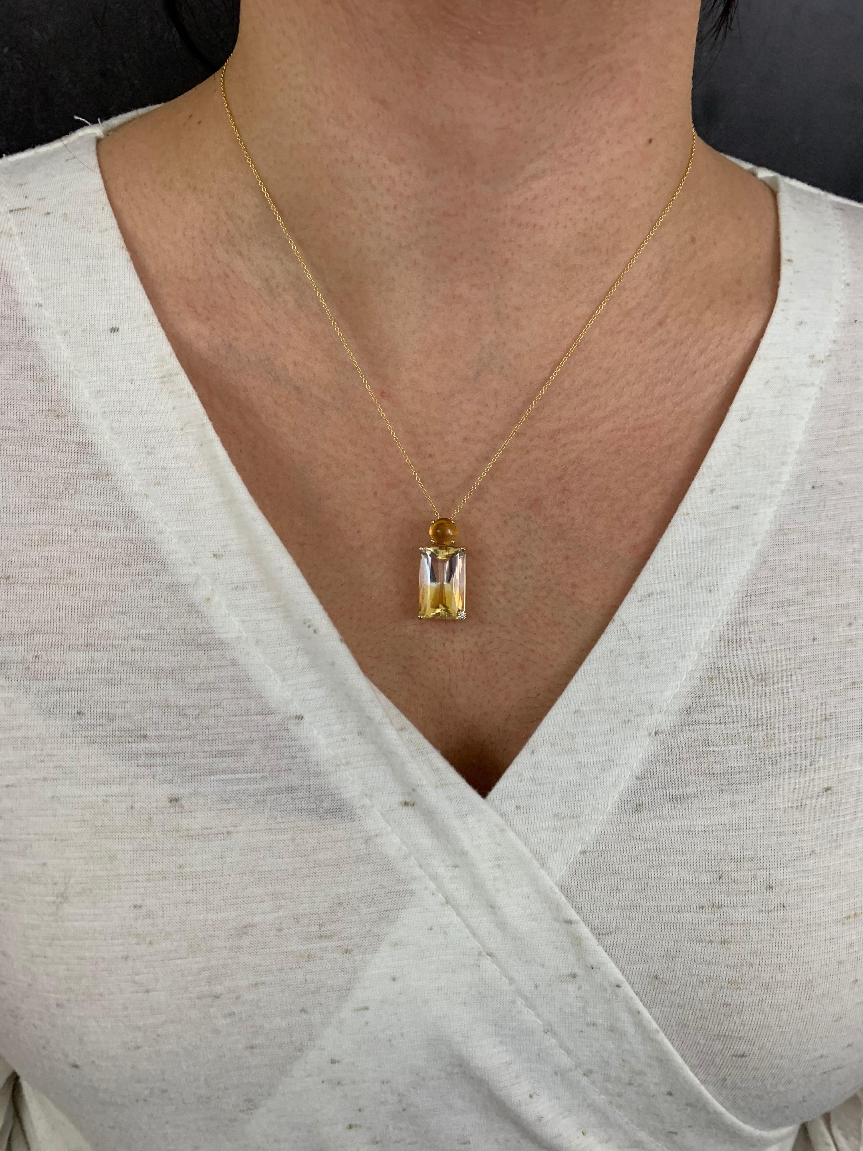 14K Yellow Gold
1 Emerald Cut Bi-Color Citrine at 13.50 Carats- Measuring 11.6 x 18.7 mm
1 Round Citrine at 1.85 Carats
1 Round White Diamond at 0.02 Carats - Clarity: SI / Color: H-I

Fine one-of-a-kind craftsmanship meets incredible quality in