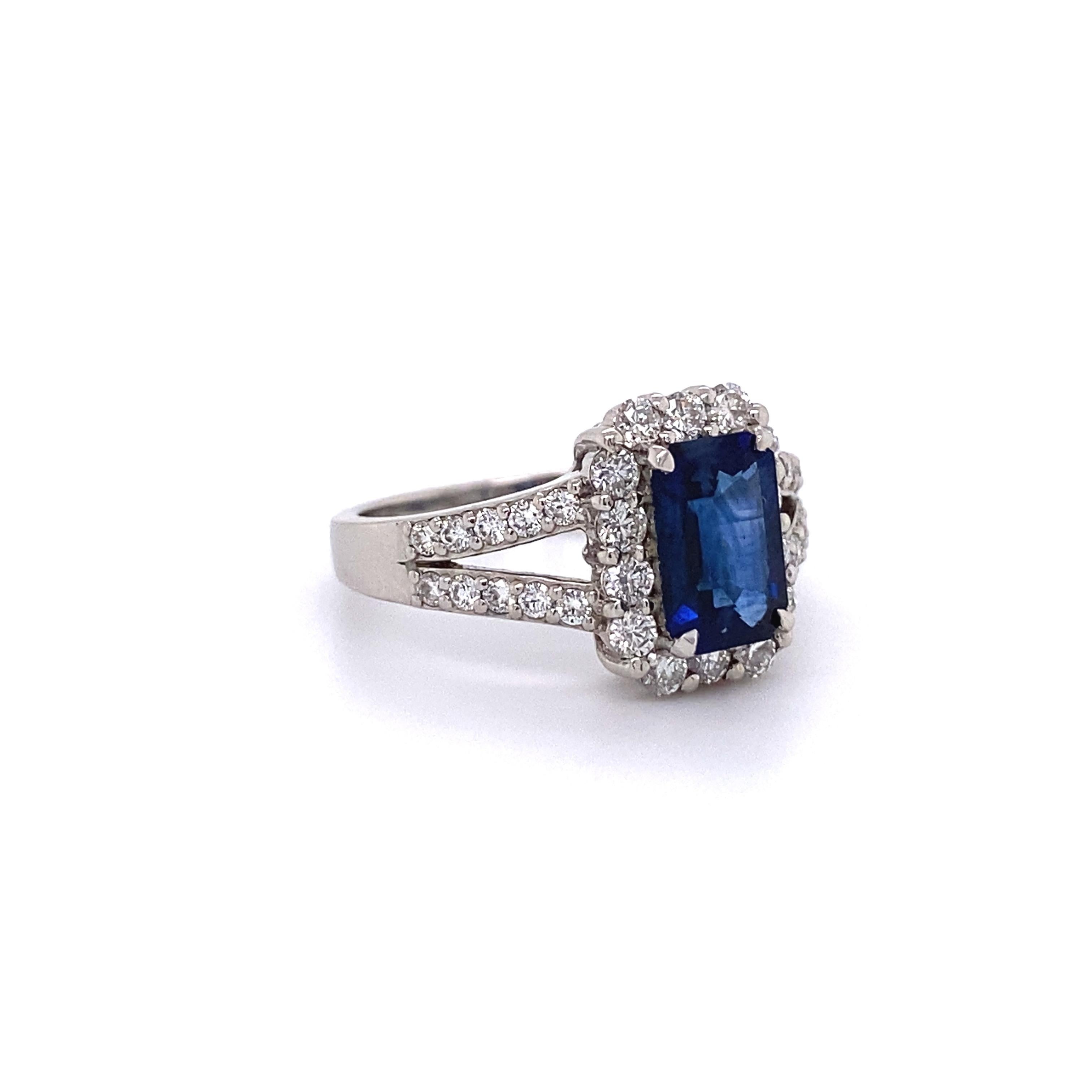 Beautiful finely detailed Emerald-cut Sapphire and Diamond Platinum Cocktail Ring. Center securely set with an Emerald cut Blue 1.47 Carat Sapphire surrounded by and accented on V-shaped shank with Diamonds approx. 0.72tctw. Dimensions: 0.77”w x