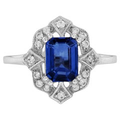 Anello con zaffiro blu taglio smeraldo e diamante aureolato in oro bianco 14 carati stile vintage