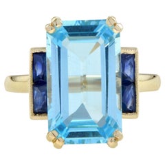 Solitär-Ring aus 14 Karat Gold mit blauem Topas im Smaragdschliff und Saphir im Art-déco-Stil
