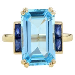 Bague solitaire de style Art déco en or 14 carats avec topaze bleue taille émeraude et saphir