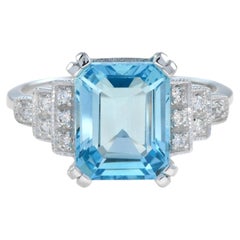 Emerald Cut Blue Topaz and Step Diamond Engagement Ring in 18K White Gold