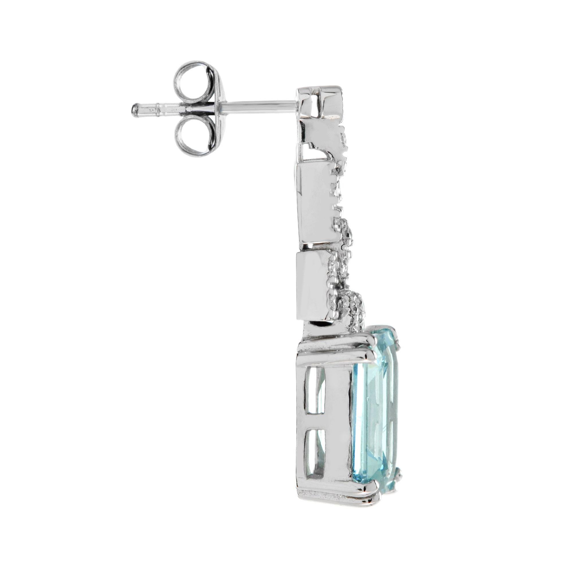 Express yourself with these insanely stylish, stunningly detail earrings with emerald cut blue topaz and diamonds. Match them with your favorite outfit to complete your look. 14K White Gold. 
Information
Style: Art Deco
Width: 8 mm.
Length: 26