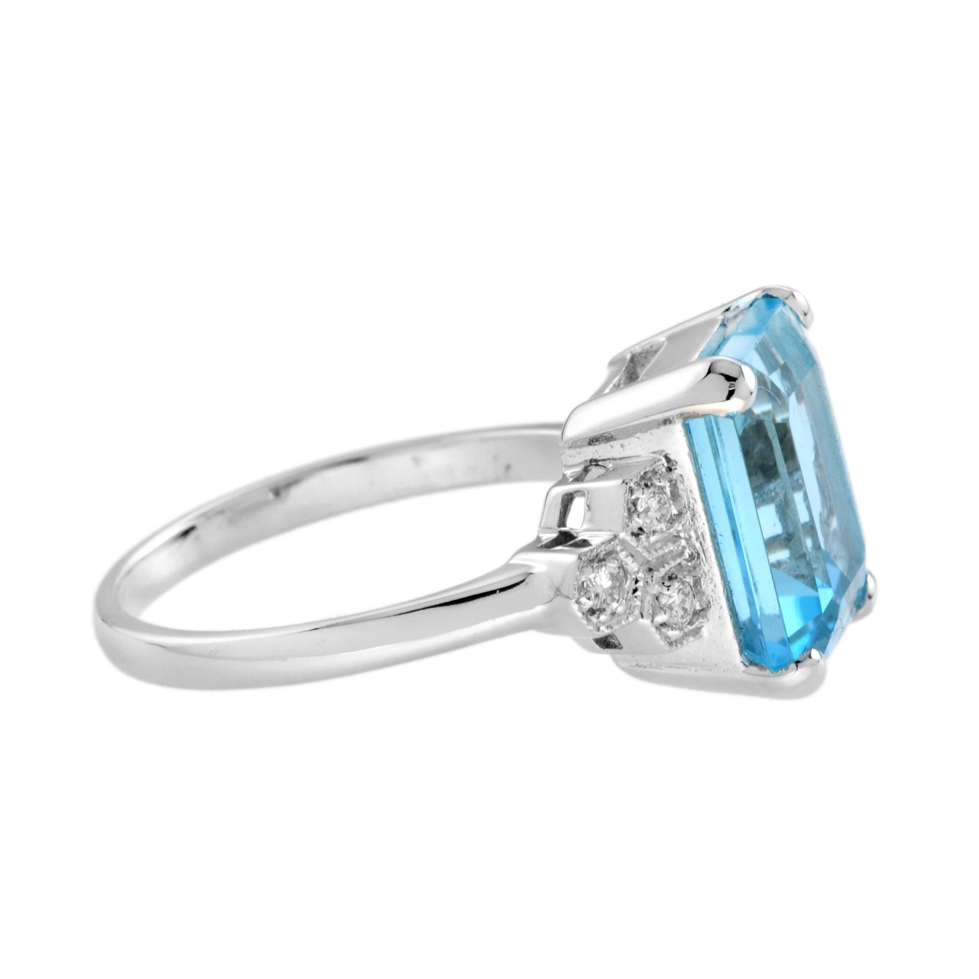 Wunderschöner Ring aus 9 Karat Weißgold, verziert mit einem blauen Topas im Smaragdschliff. Das mittlere Stück ist auf beiden Seiten mit runden Diamanten verziert. Ein zeitloses Schmuckstück, das sich nicht nur für ein besonderes Geschenk, sondern